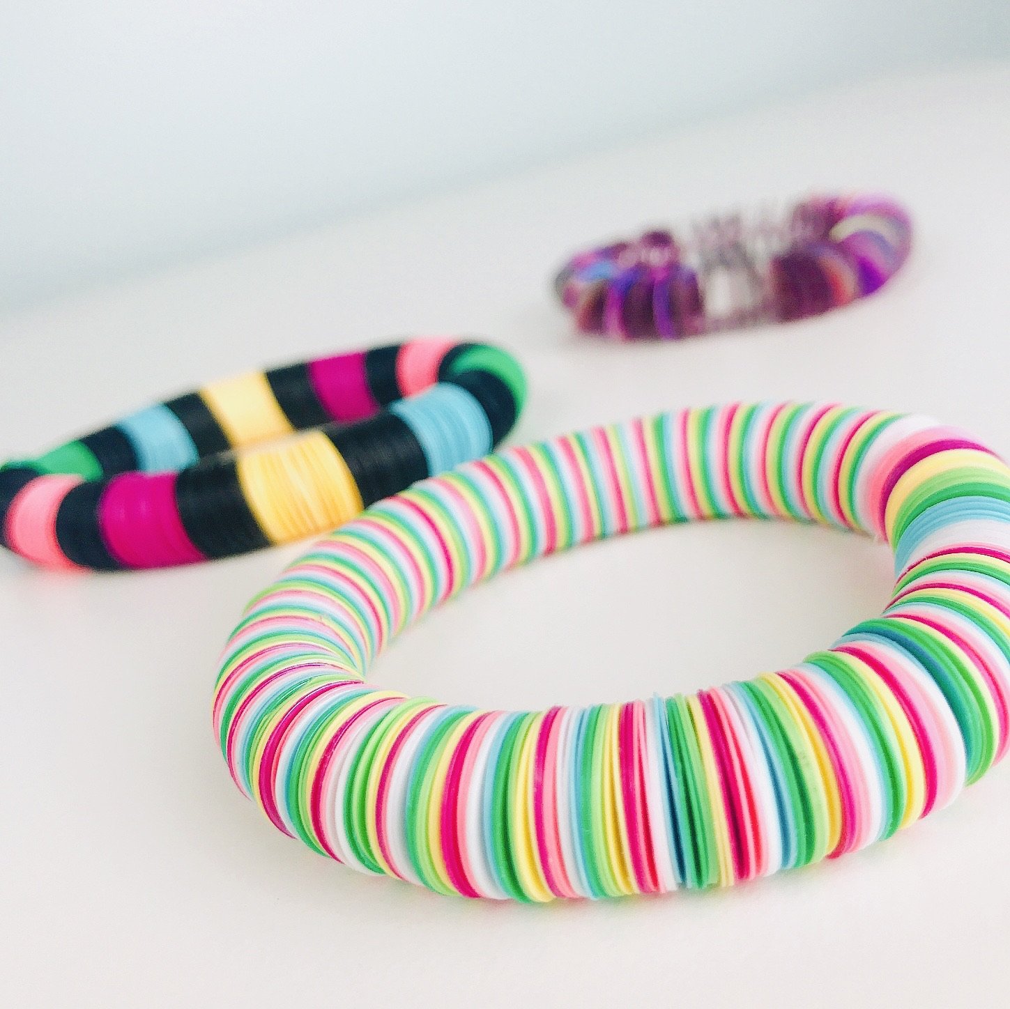 DIY Bracelet Kit - Funfetti Edition featuring colorful holographic sequins, elastic cord, and spacer beads for crafting three unique bracelets.