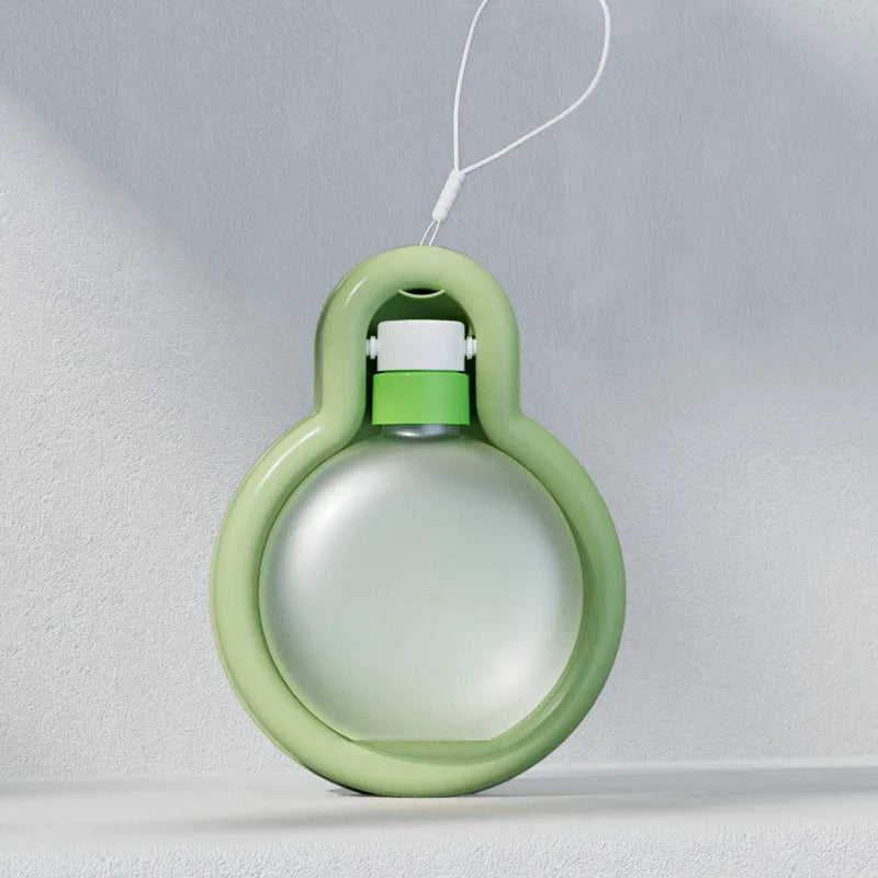 Lightweight portable dog water bottle in green, designed for outdoor travel with a wide drinking tank and stable base.