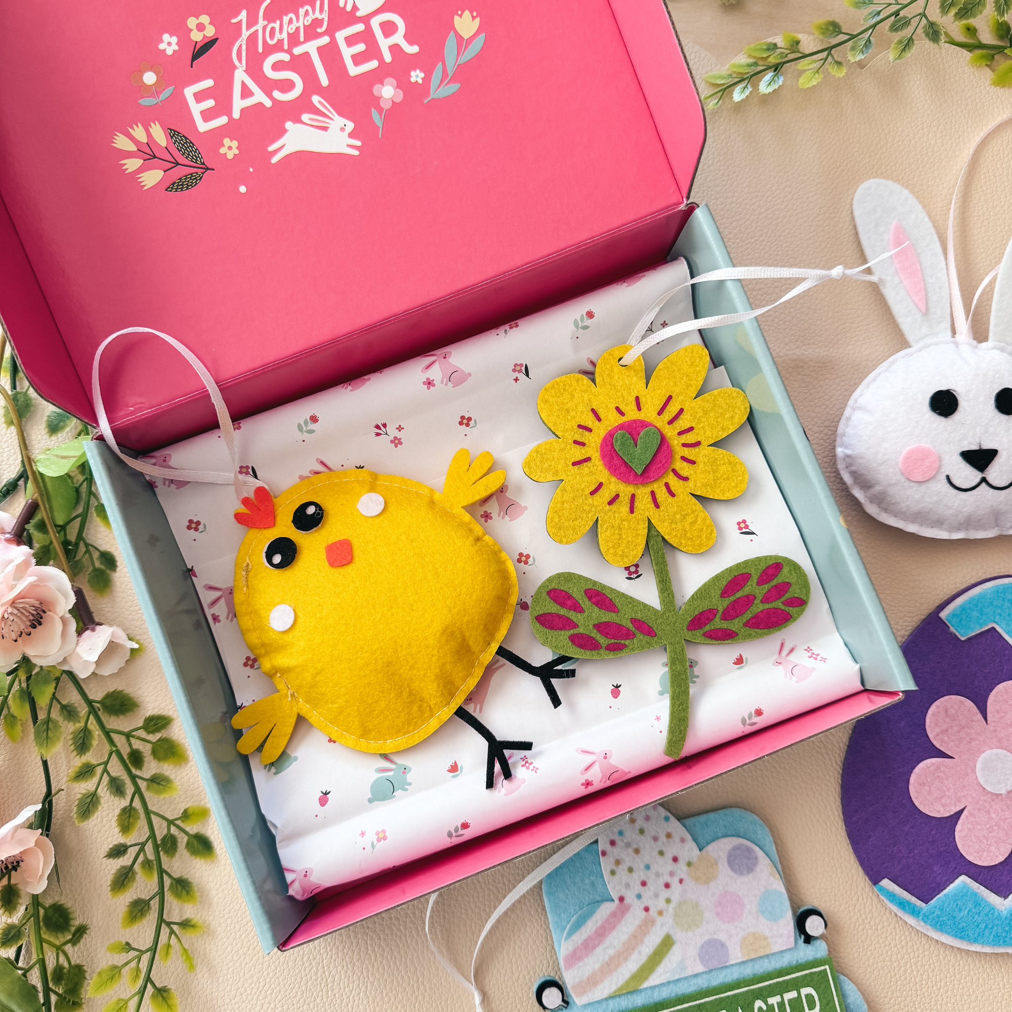 A colorful assortment of felt Easter crafts including bunnies, eggs, and chicks, showcasing vibrant felt stickers and no-sew designs.