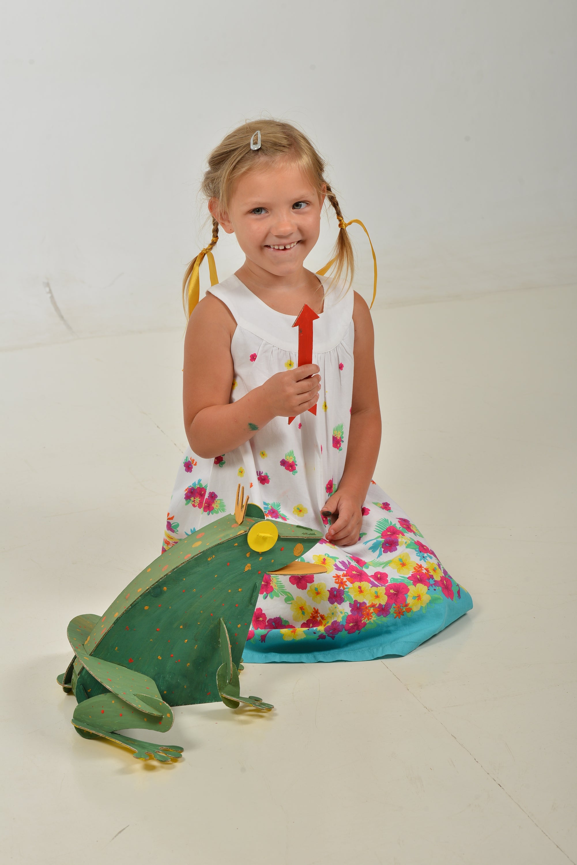 A colorful assembled cardboard frog model kit, showcasing its intricate parts and vibrant paint, perfect for children to build and decorate.