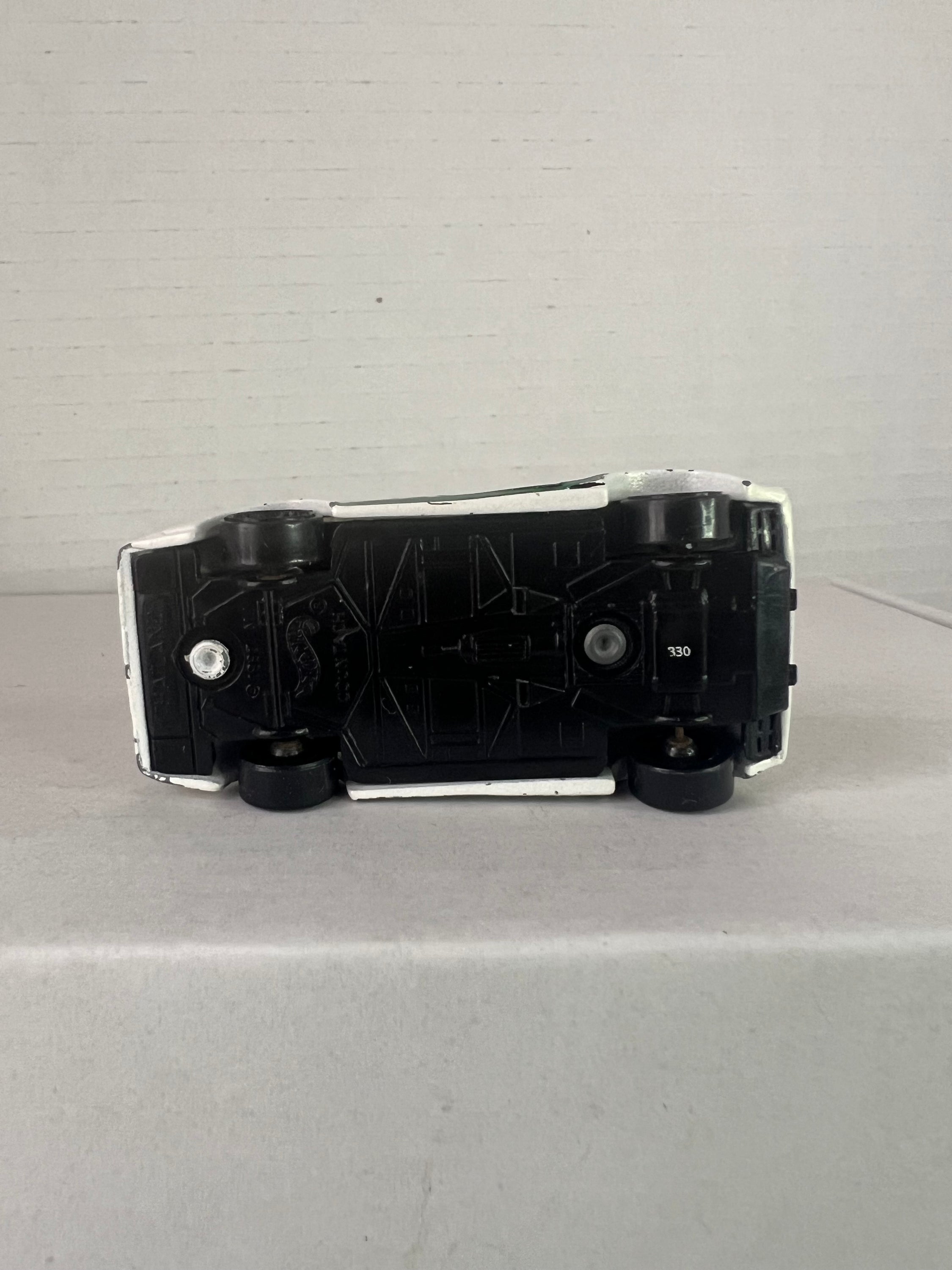 Hot Wheels 25th Anniversary Lamborghini Countach die-cast model in white, showcasing its sleek design and details.