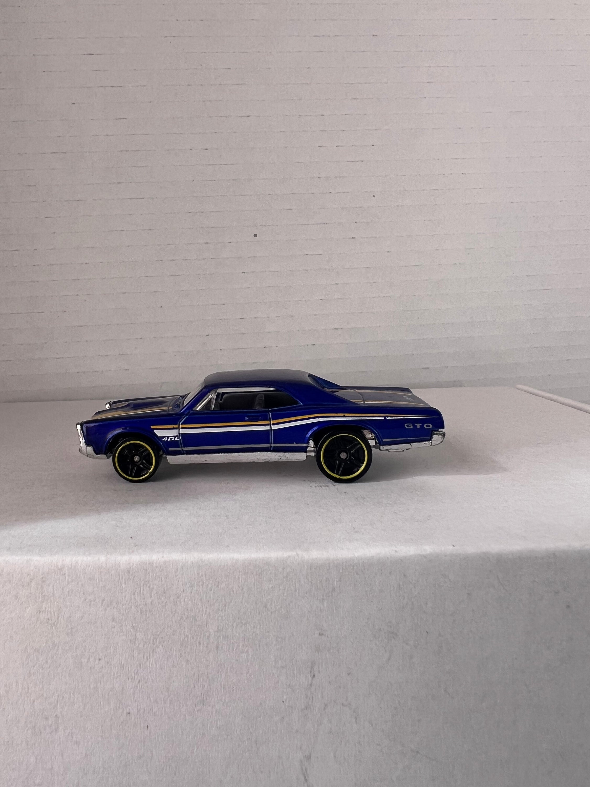 Hot Wheels HW Workshop (2015) set featuring '67 Pontiac GTO and '86 Monte Carlo SS die-cast cars in vibrant colors.