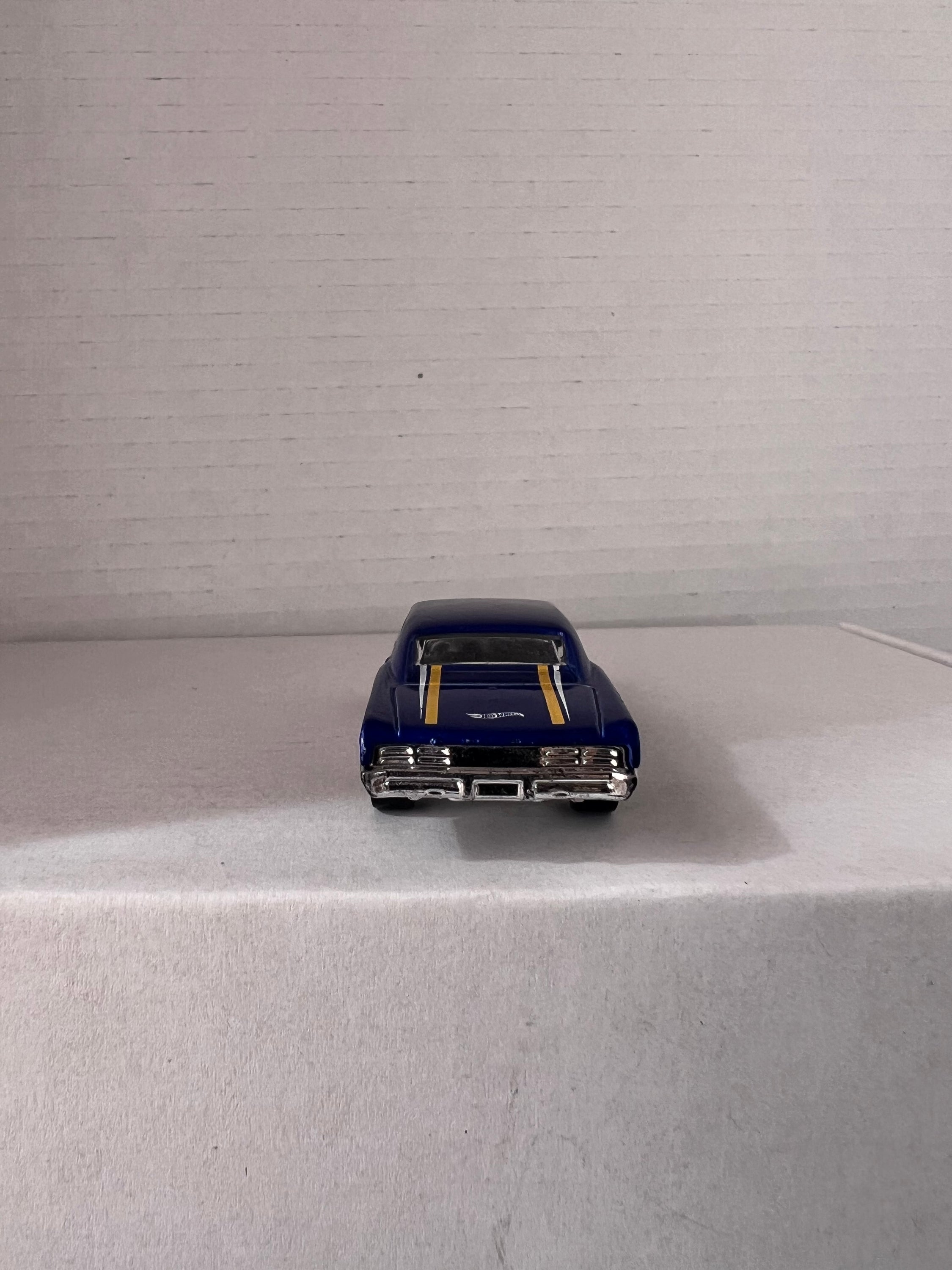 Hot Wheels HW Workshop (2015) set featuring '67 Pontiac GTO and '86 Monte Carlo SS die-cast cars in vibrant colors.