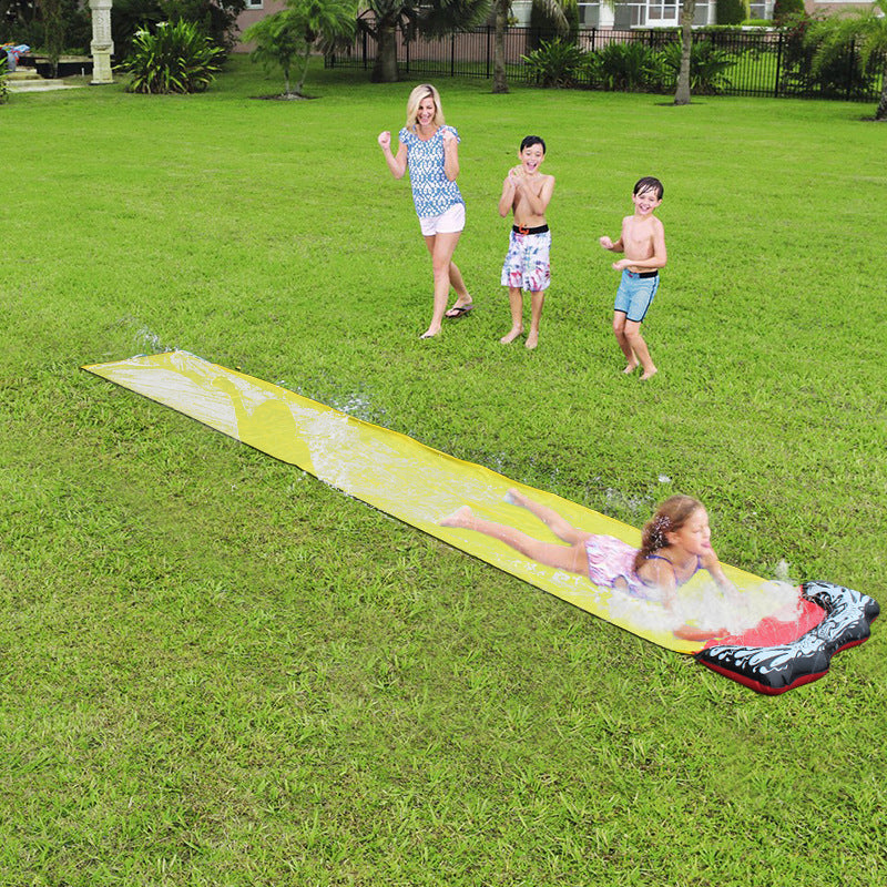 A colorful inflatable water slide set up in a garden, featuring a sprinkler system and children playing joyfully.