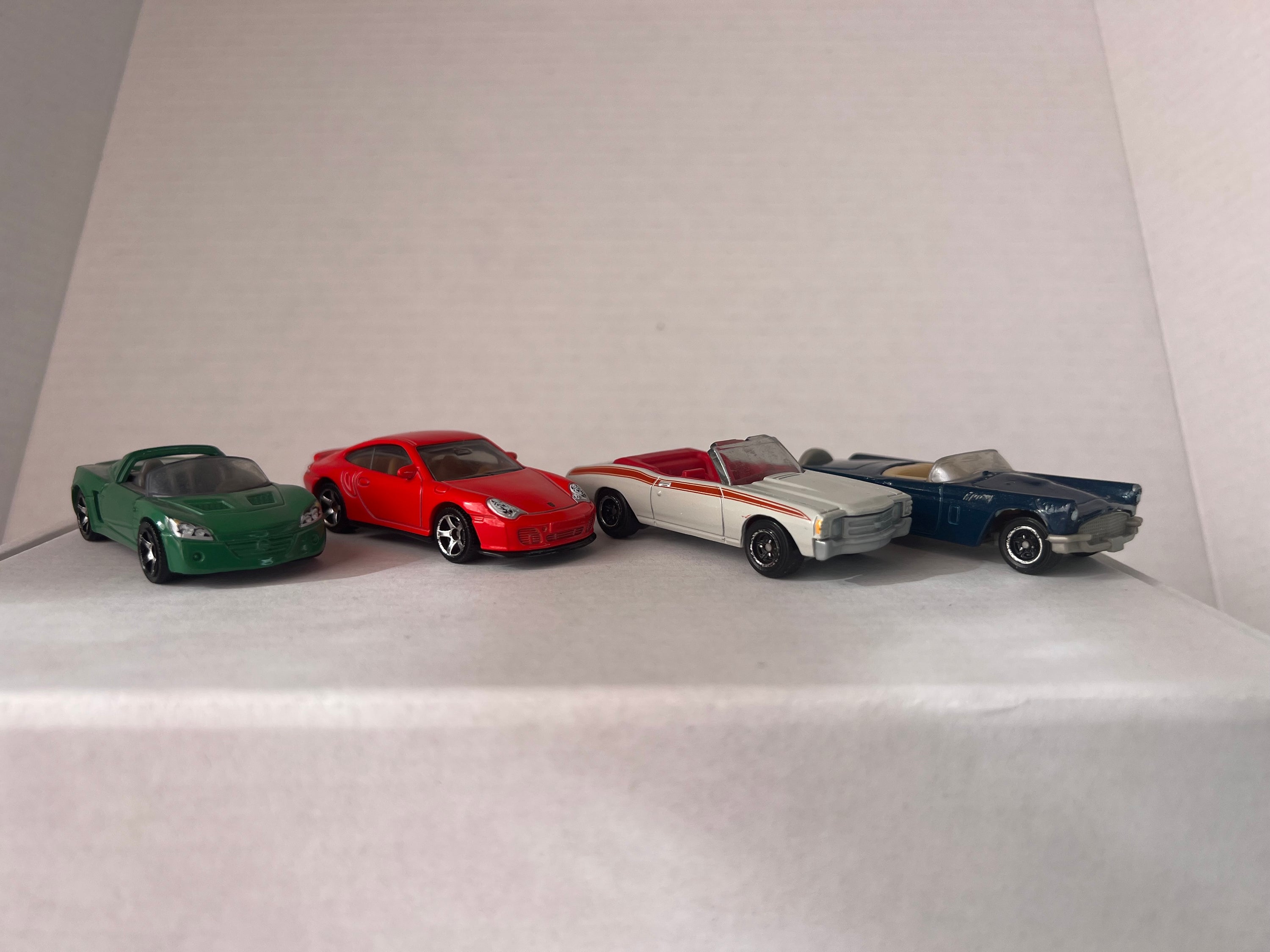 Matchbox Open Road-Sters 2017 set featuring four die-cast cars: Opel Speedster, Porsche 911 Turbo, 1971 Chevy Chevelle, and 1957 Ford Thunderbird.
