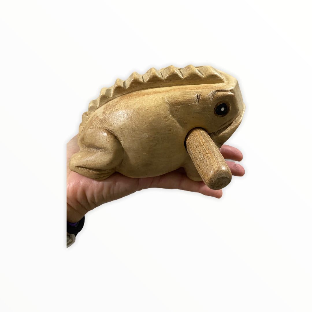 Natural wooden frog with mallet, showcasing craftsmanship and design.