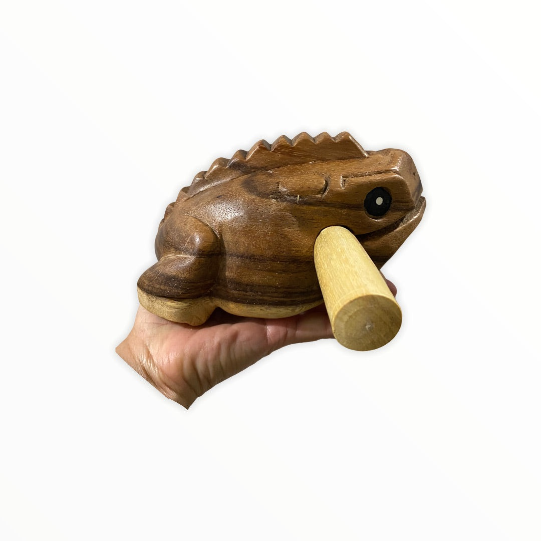 Natural wooden frog with mallet, showcasing craftsmanship and design.