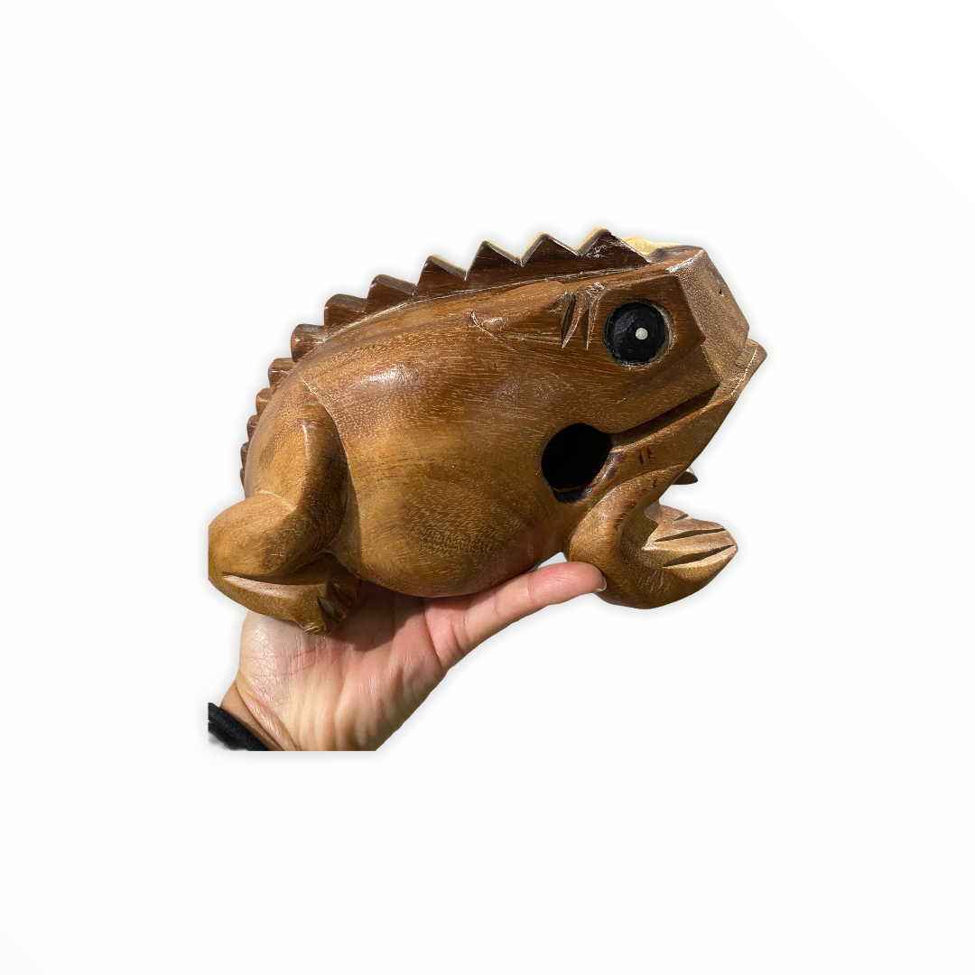 Natural wooden frog with mallet, showcasing craftsmanship and design.