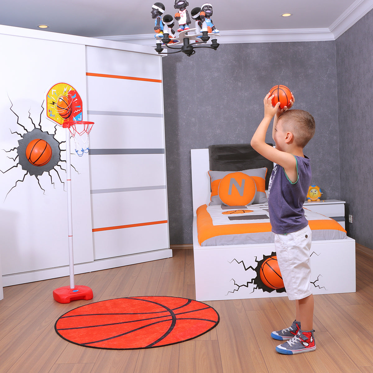 Child shooting basketball in bedroom.
