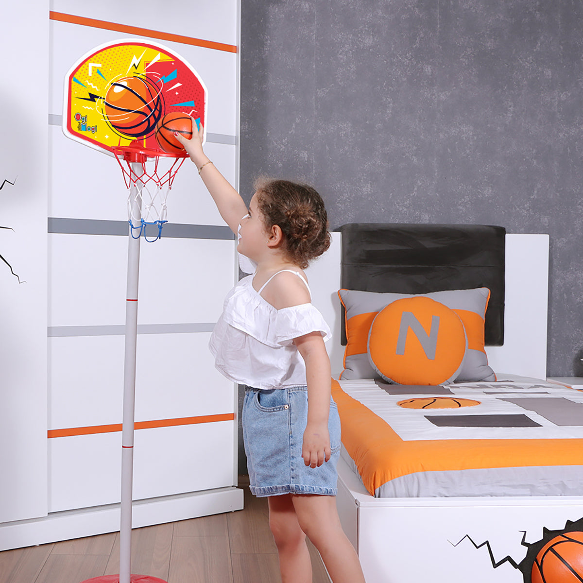 Child playing with mini basketball hoop.