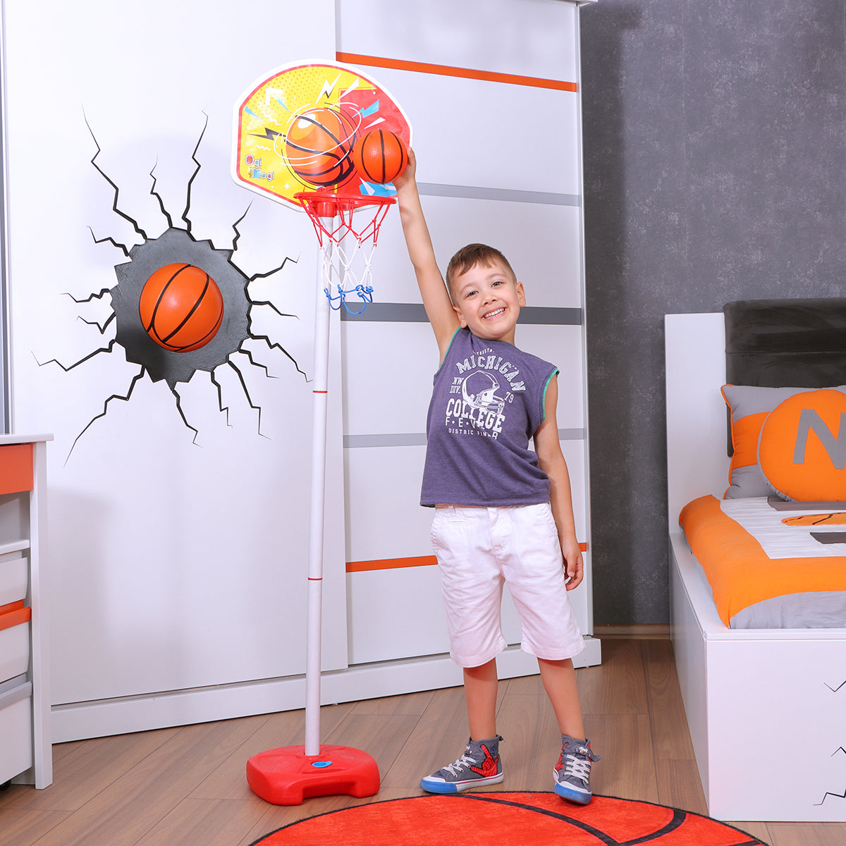 Child playing with indoor basketball hoop.