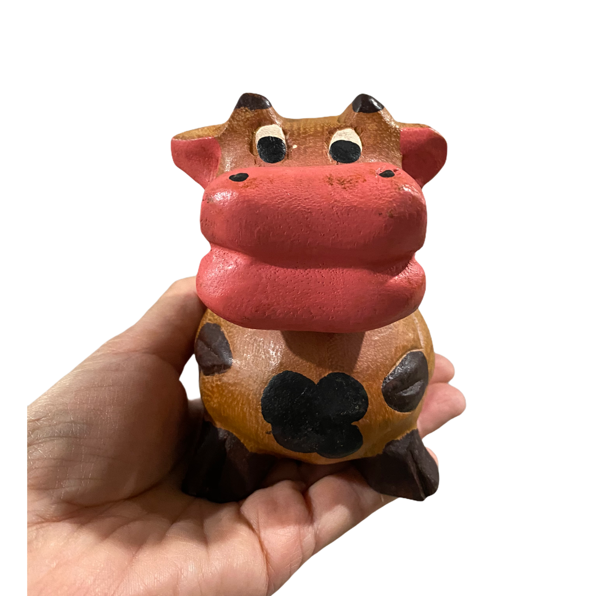 A hand-painted wooden musical whistle shaped like a cartoon cow, showcasing vibrant colors and intricate details, perfect for home decor.
