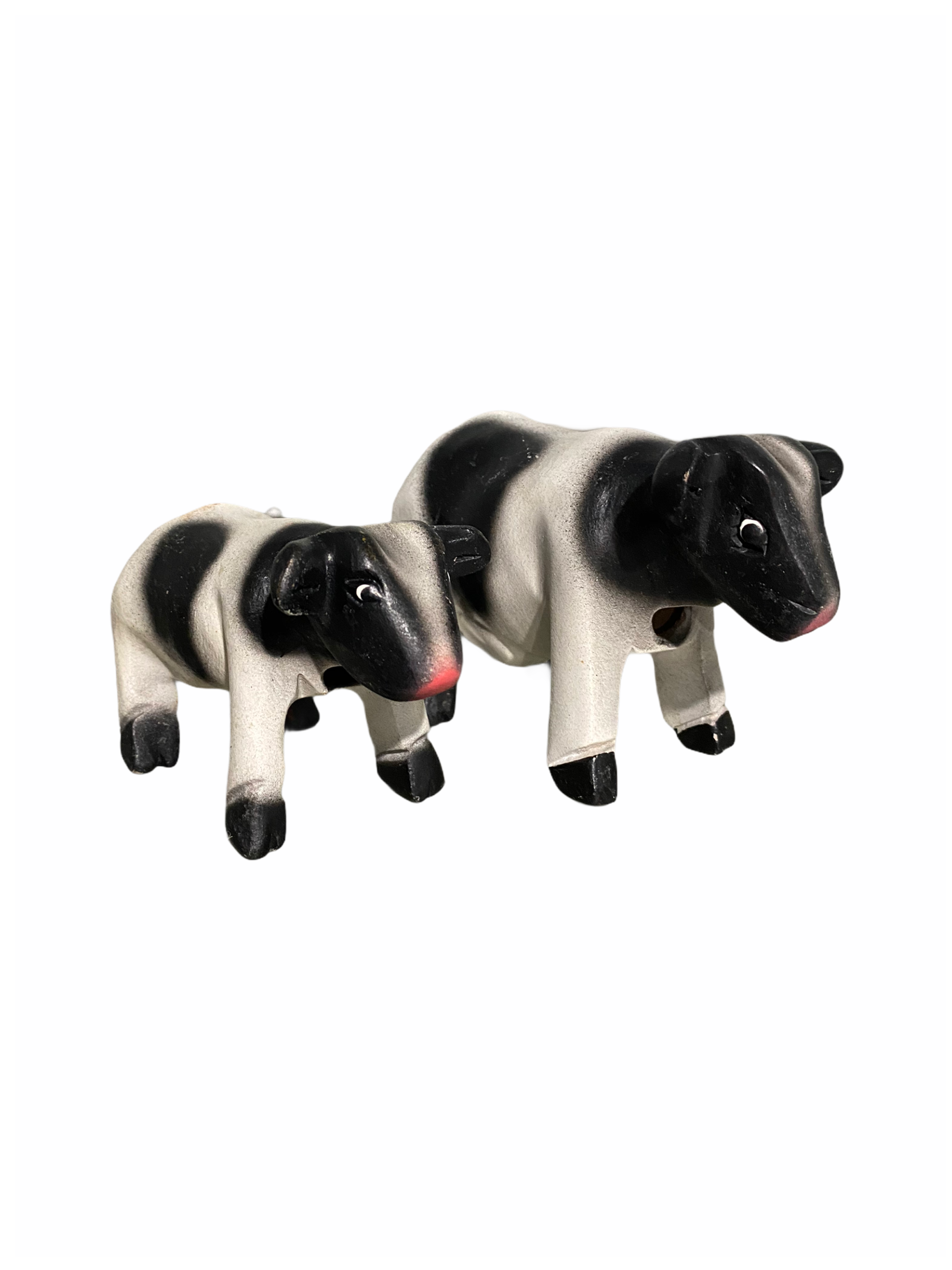 A beautifully handcrafted wooden cow whistle, painted in vibrant colors, showcasing intricate details and a whimsical design.