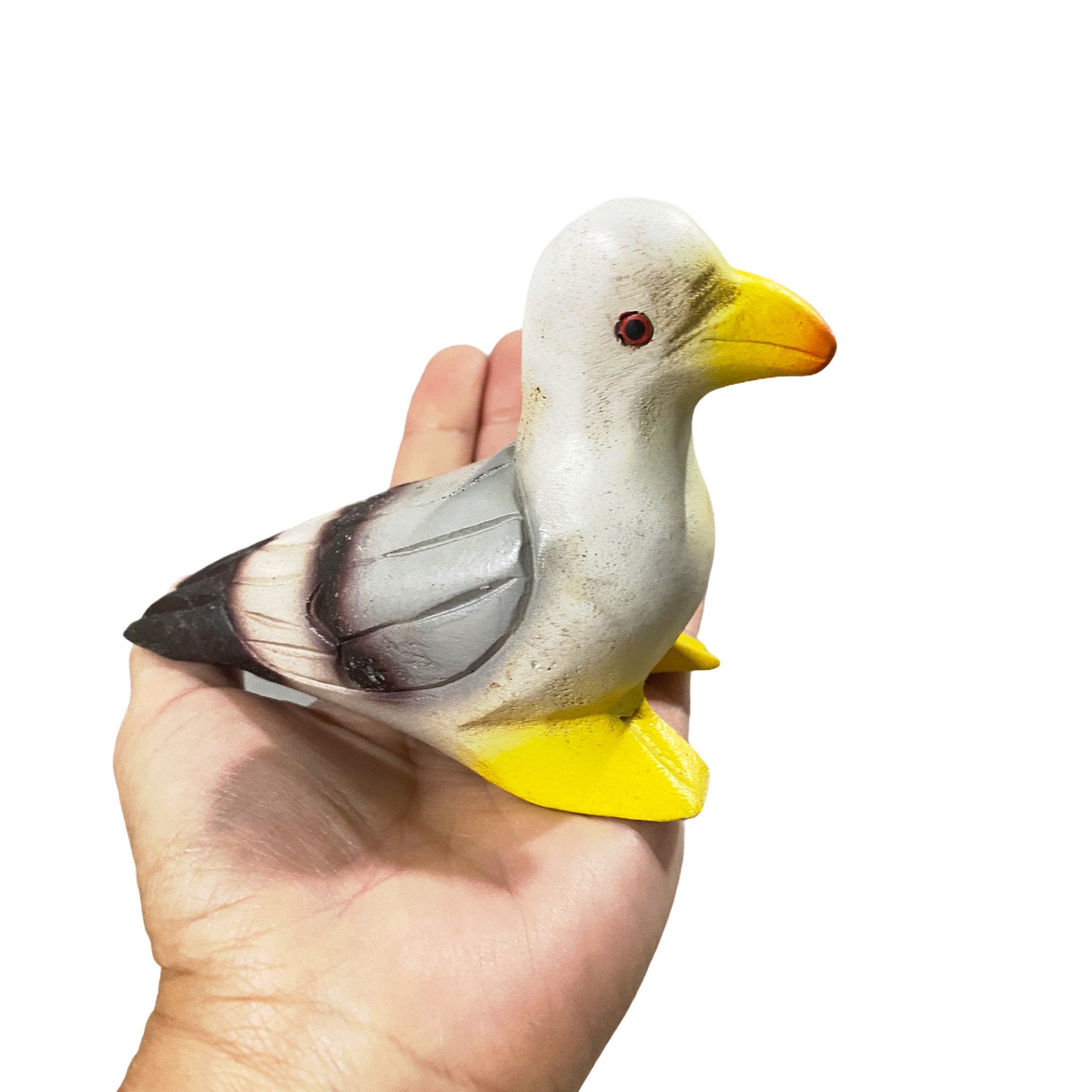 A beautifully crafted painted wooden pigeon instrument that whistles, showcasing intricate details and a shiny finish.