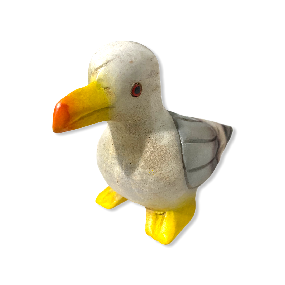 A beautifully crafted painted wooden pigeon instrument that whistles, showcasing intricate details and a shiny finish.