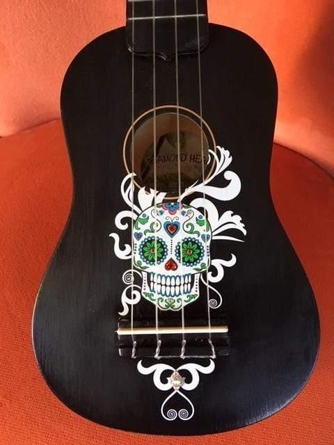 Rozanna's Sugar Skull Mariachi Ukulele featuring vibrant sugar skull design and Swarovski crystals, showcasing artistic craftsmanship.