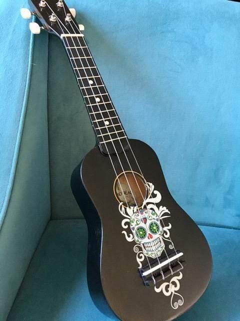 Rozanna's Sugar Skull Mariachi Ukulele featuring vibrant sugar skull design and Swarovski crystals, showcasing artistic craftsmanship.