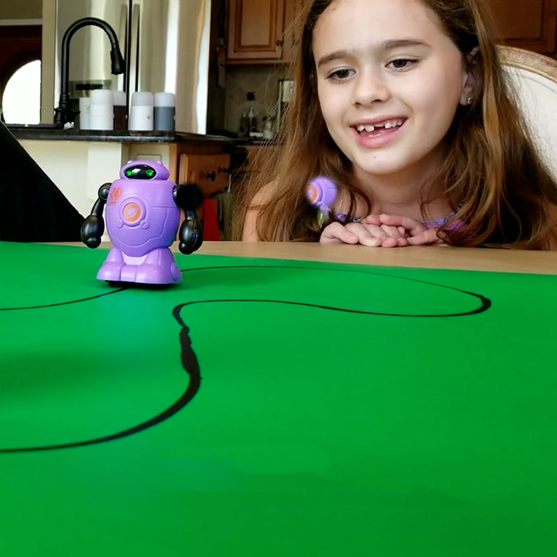 Tracer Draw & Follow Inductive Robot in action, following a hand-drawn black line on white paper.