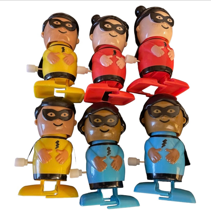 A colorful assortment of six wind-up superhero toys in yellow, red, and blue, showcasing their vibrant designs.