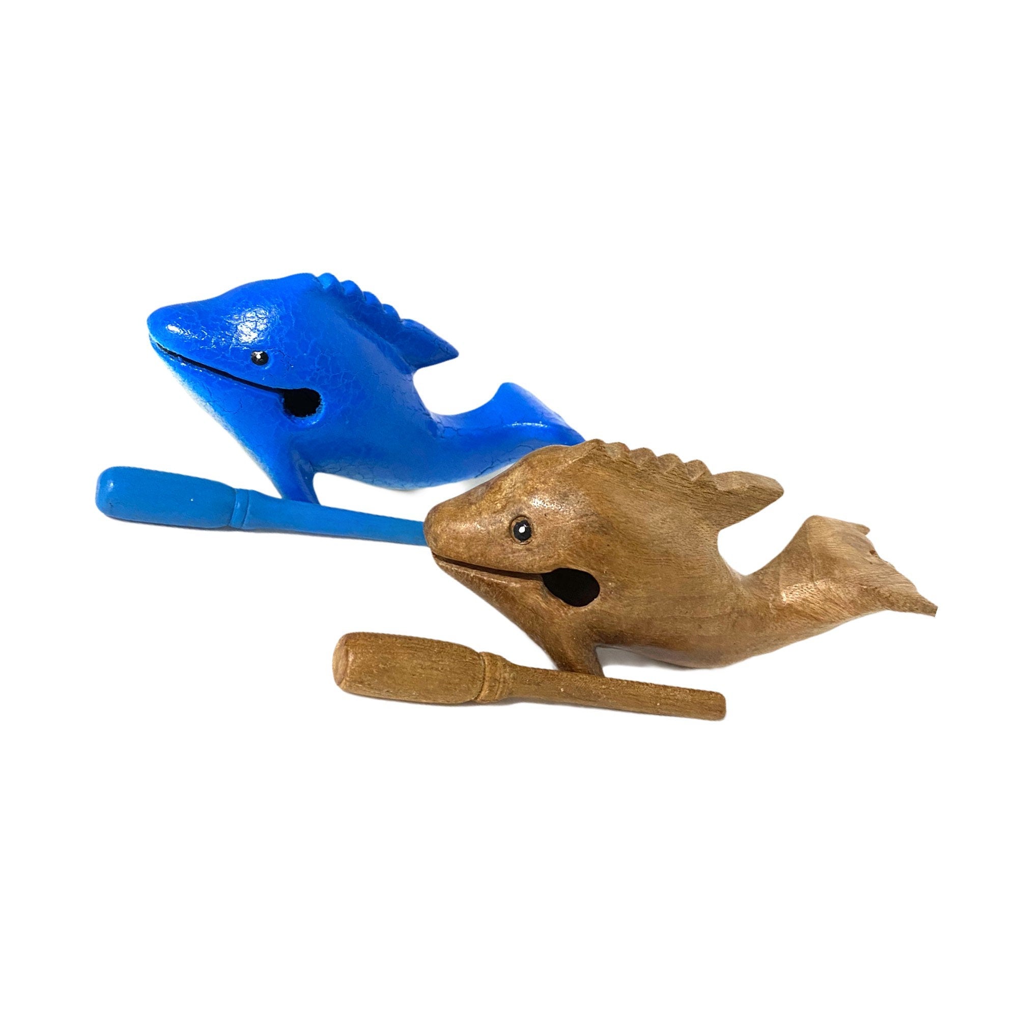 A handcrafted wooden dolphin percussion instrument with a smiling face, small mallet, and smooth finish, perfect for music and decor.