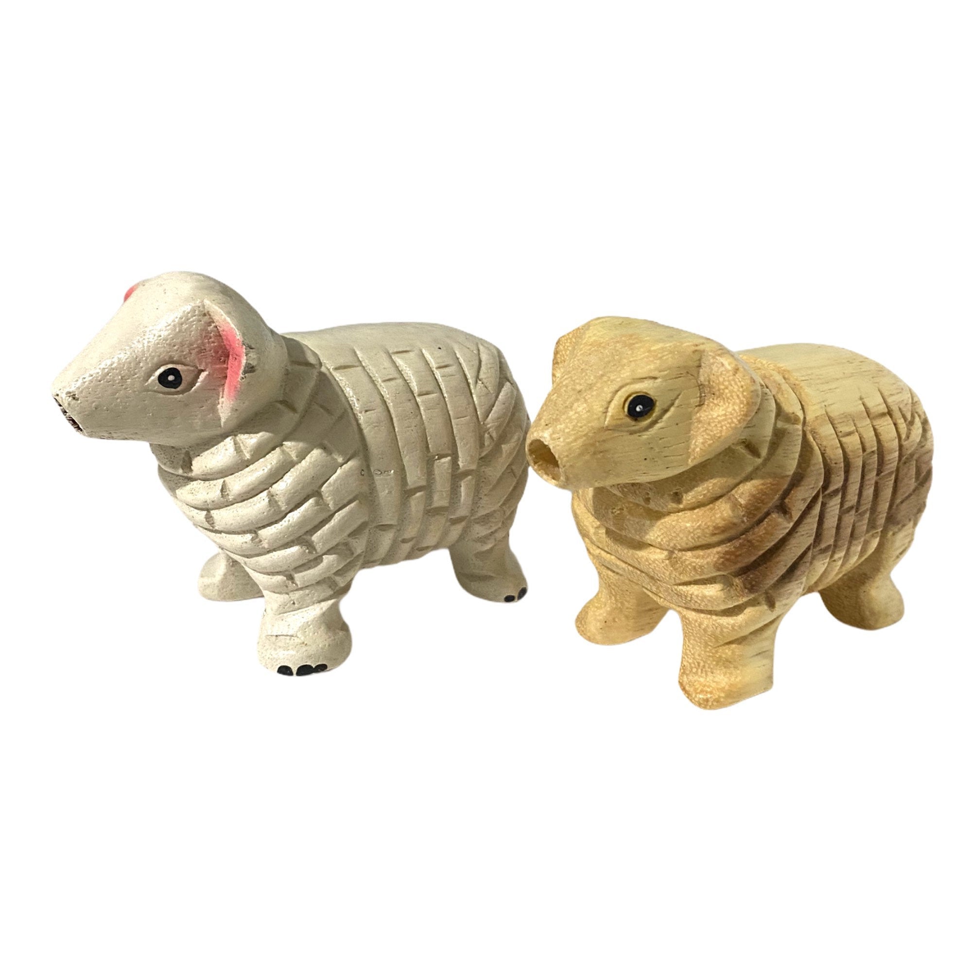 A charming wooden musical whistle shaped like a sheep, showcasing its intricate design and natural wood finish.