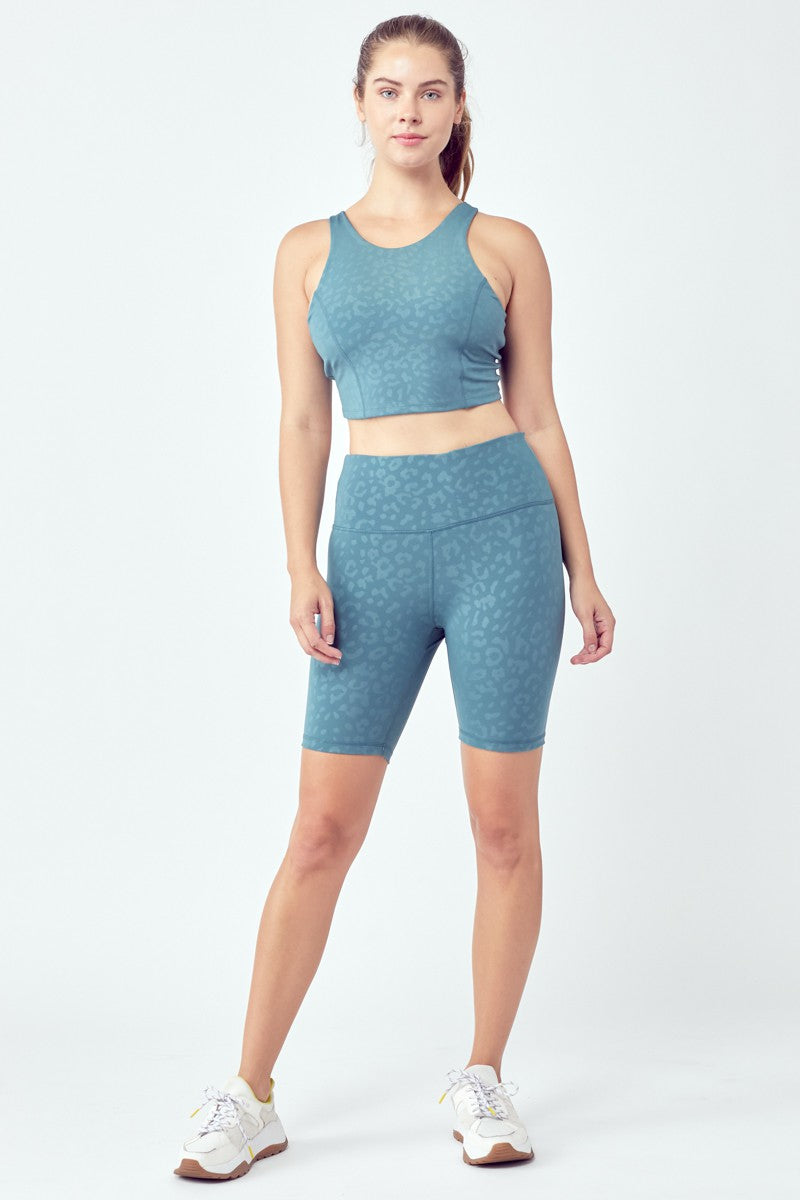 A stylish 2 Piece Fringed Leopard Pattern Active Set featuring high waist biker shorts and a cropped top in vibrant multi-colors.