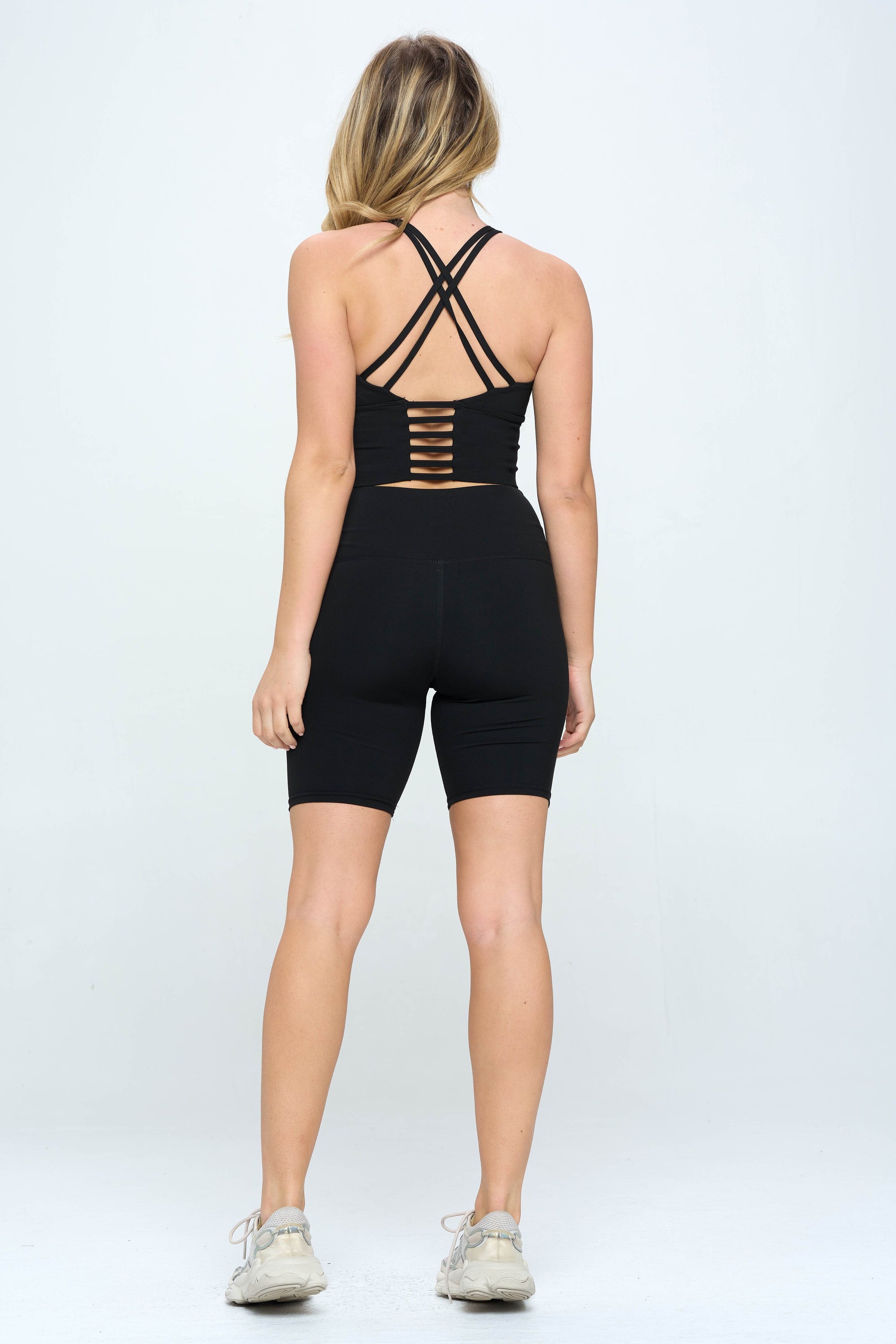 A stylish model wearing a Biker Shorts Set, showcasing tummy control and moisture-wicking fabric in a vibrant color.