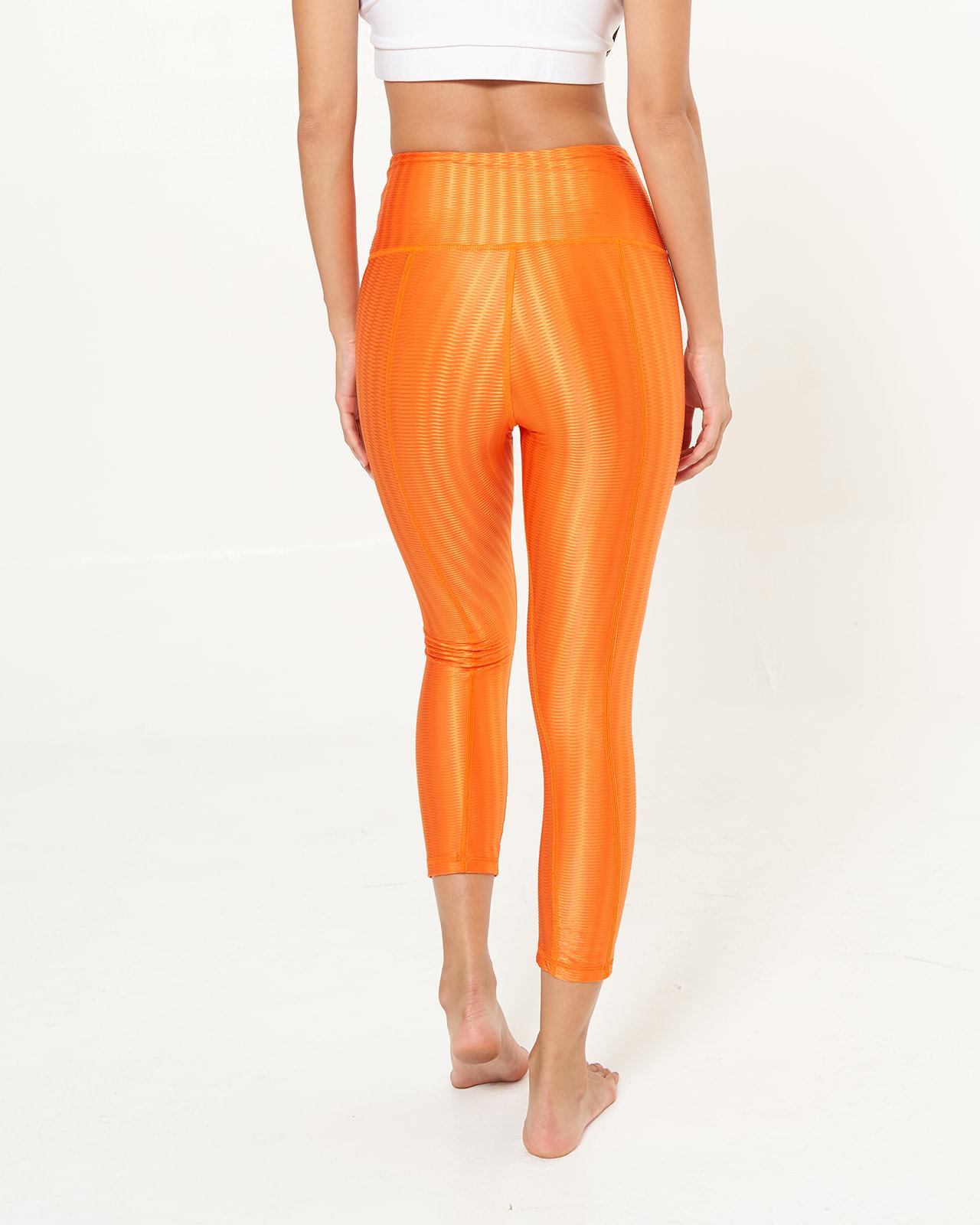 Hi-Rise Capri in Tangerine Zap pattern, showcasing vibrant colors and a stylish design, perfect for workouts and daily wear.