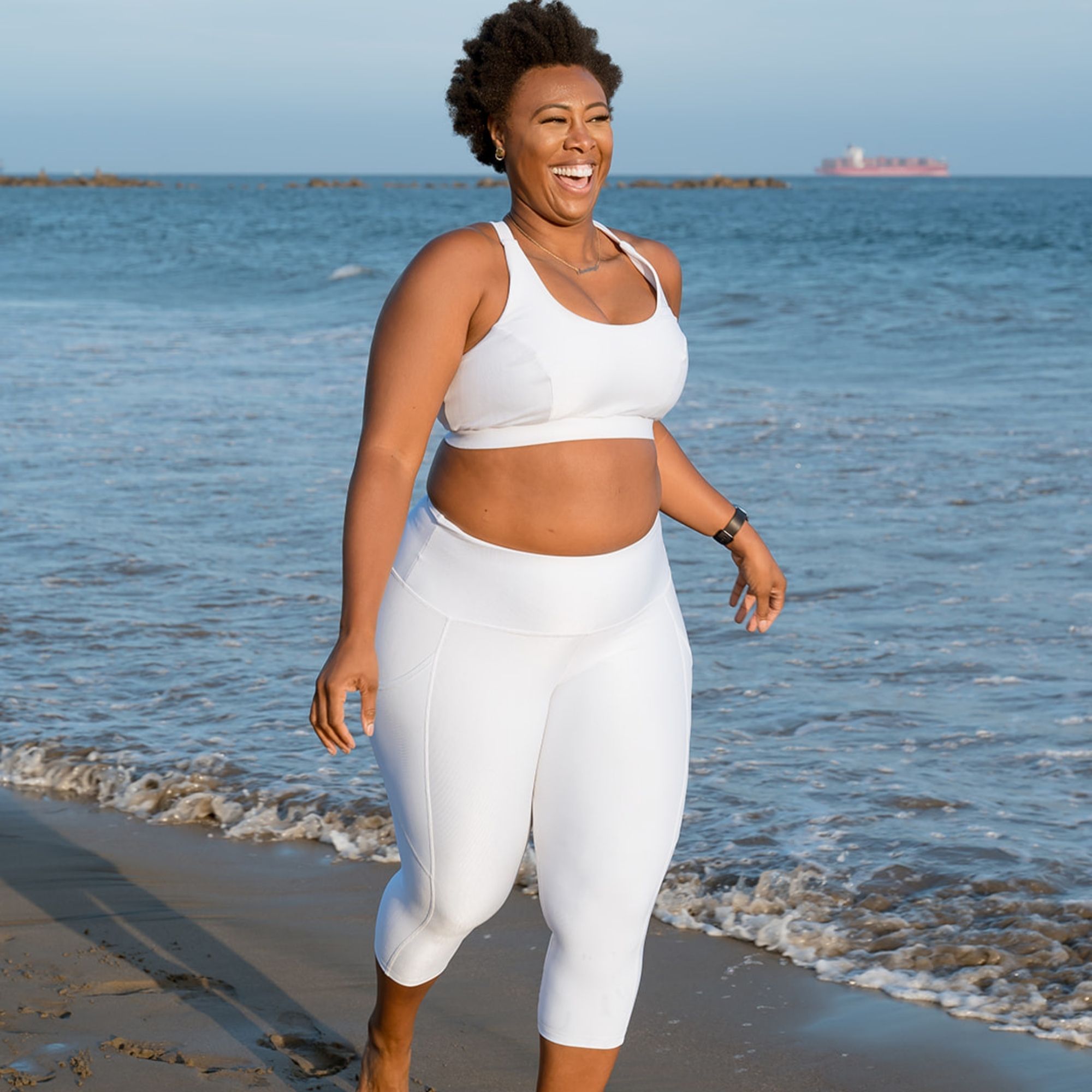 Hi-Rise Curved-Pocket Capri in white rib pattern, featuring a high-rise waist and curved pockets for smartphone storage.