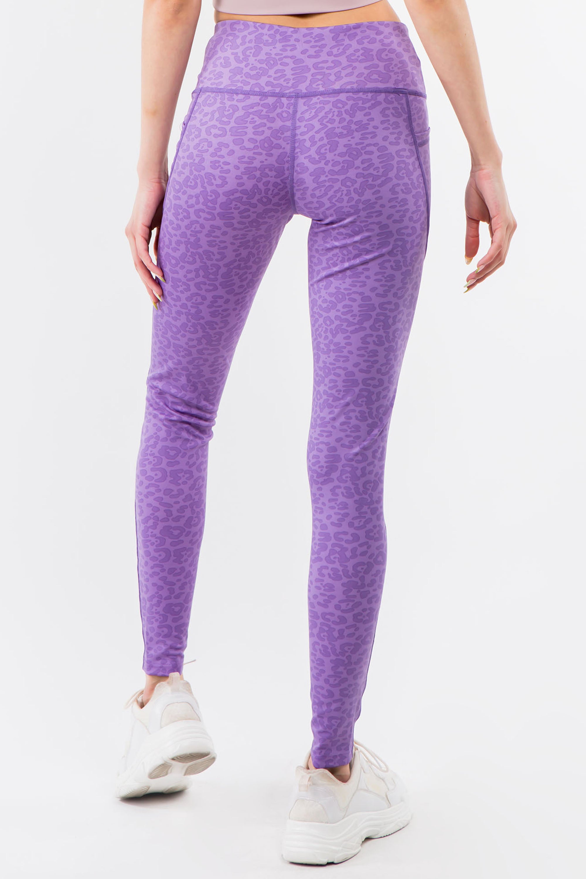A pair of high-waisted purple leopard leggings displayed on a white background, showcasing their vibrant color and flat seam design.