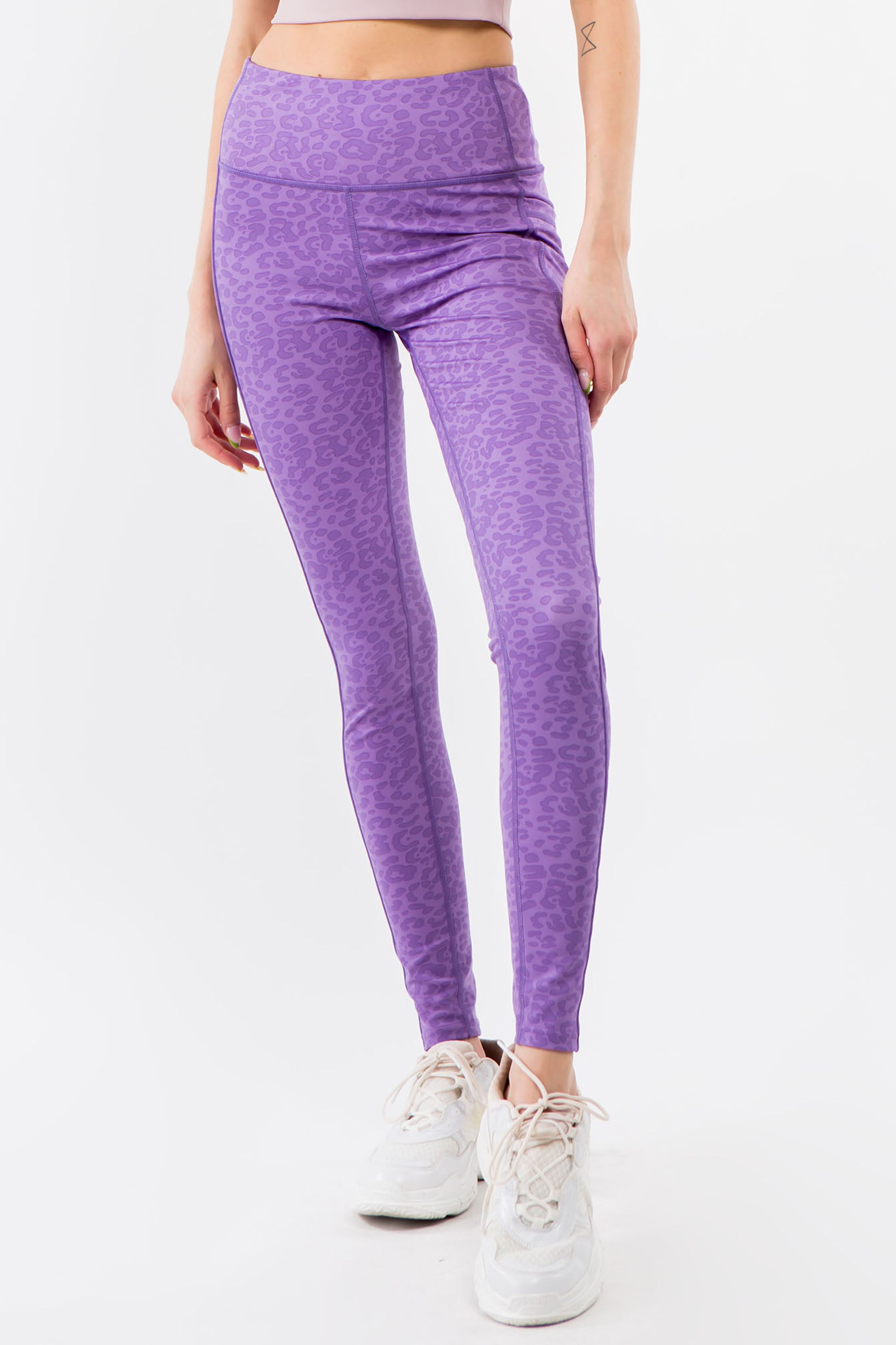 A pair of high-waisted purple leopard leggings displayed on a white background, showcasing their vibrant color and flat seam design.