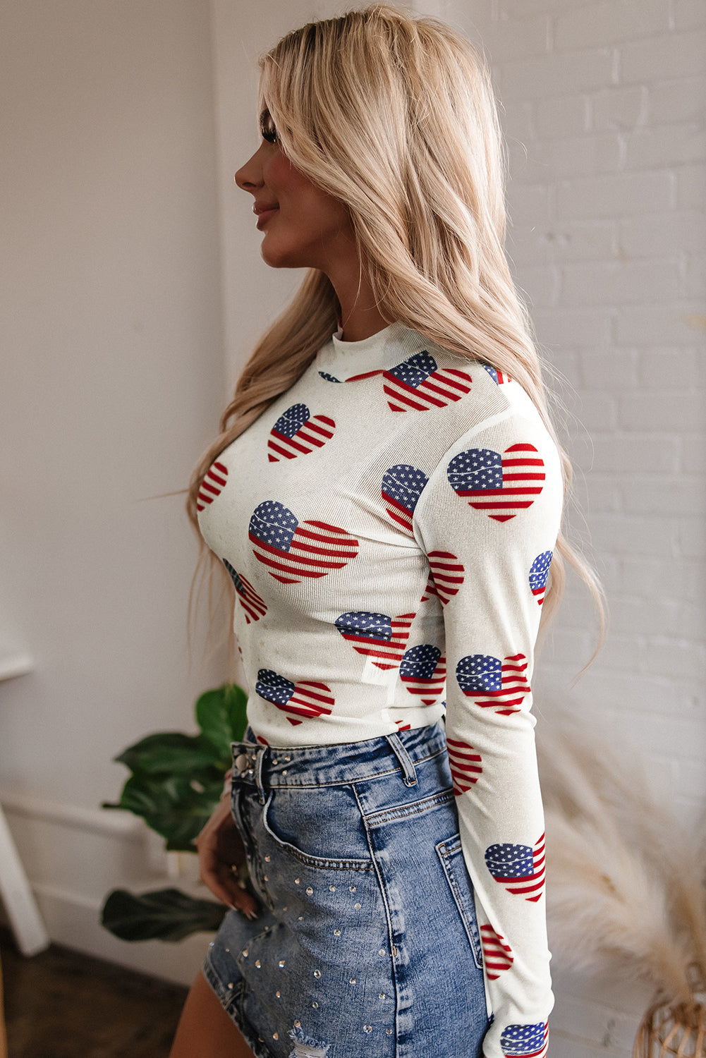 Americana Heart Mesh Long Sleeve Bodysuit featuring American flag print and glittered mesh fabric.