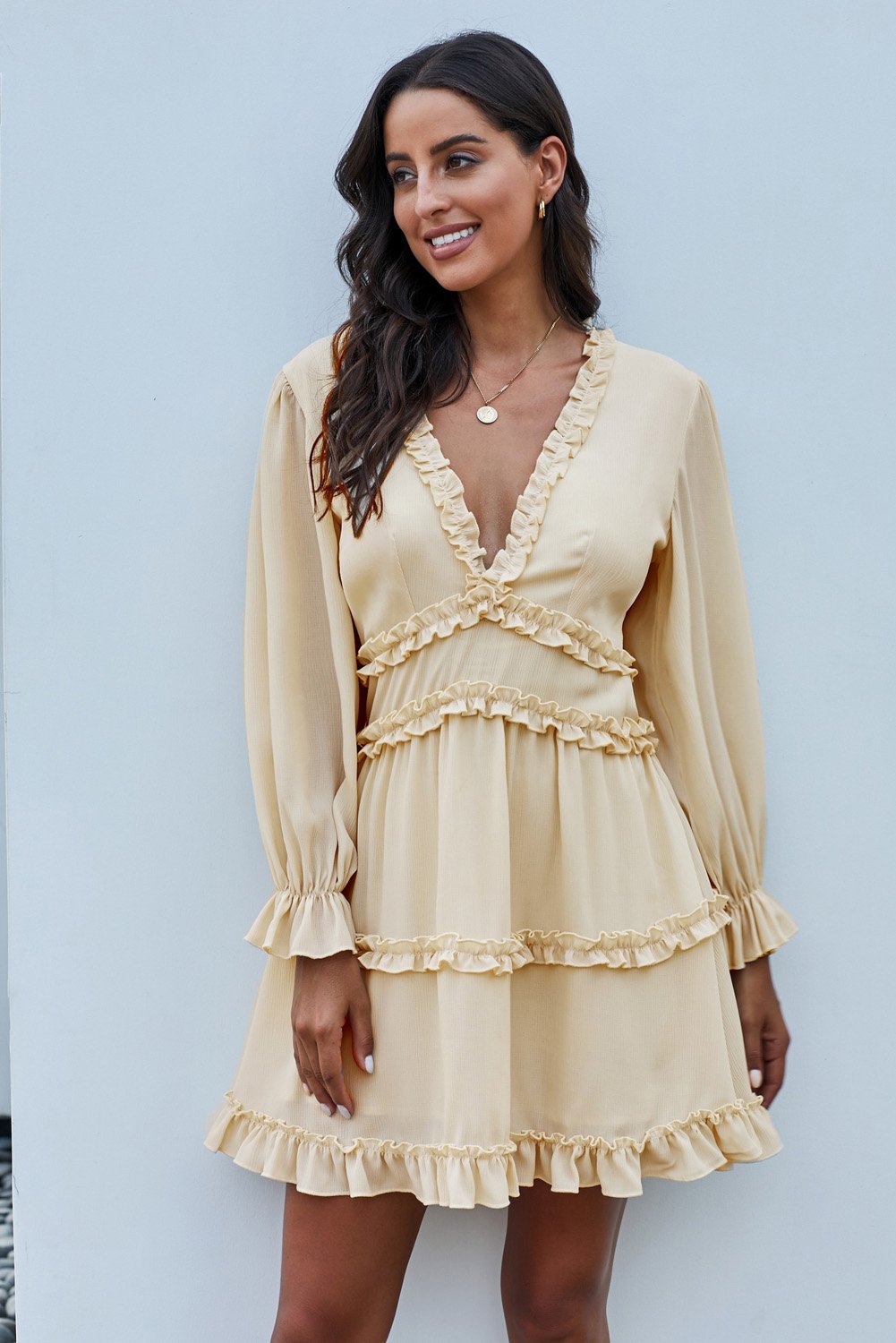 Beige long sleeve dress featuring v-neckline, ruffle detailing, and open back design, perfect for casual spring and autumn wear.