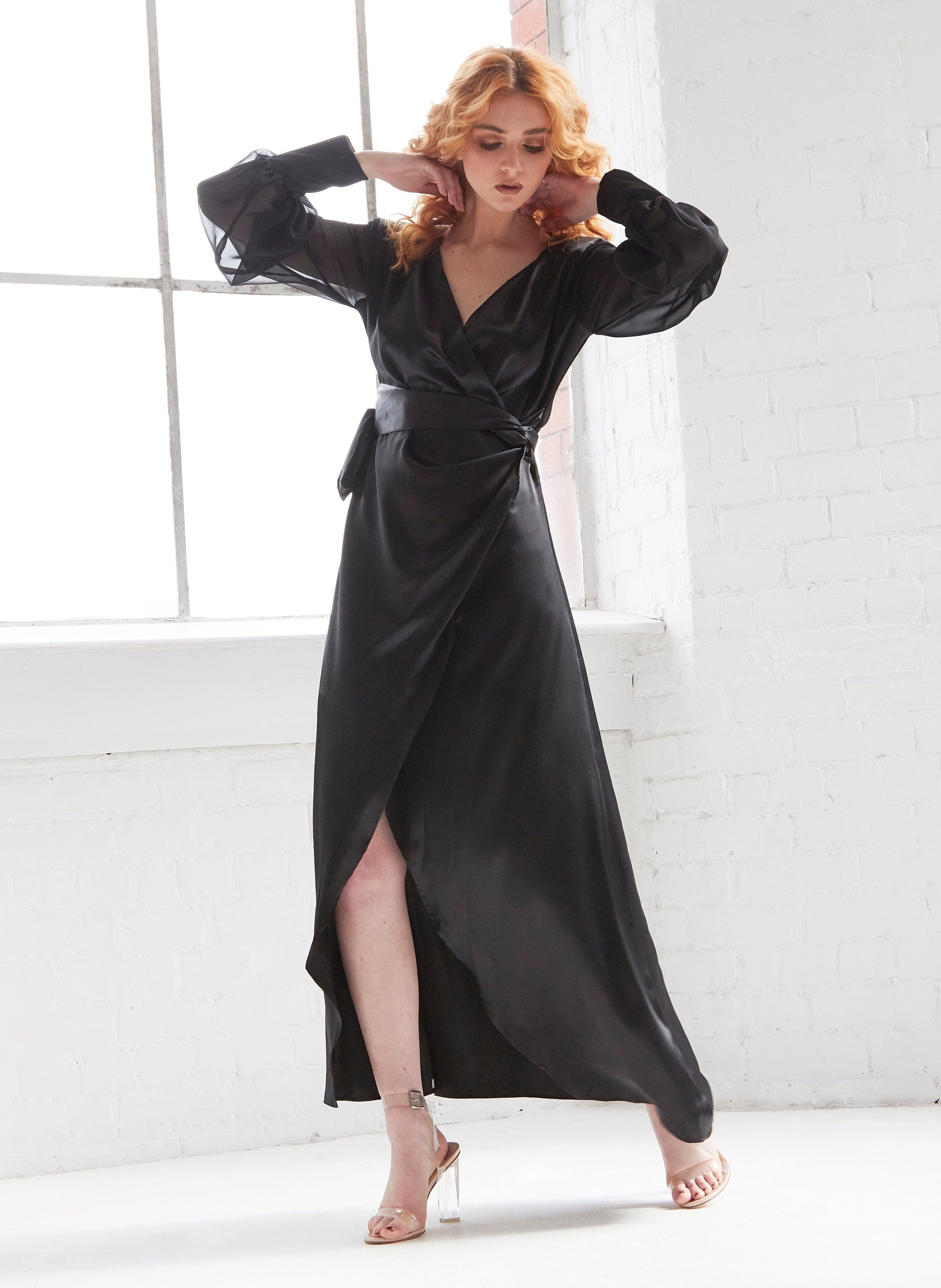 Amber Black Wrap Maxi Dress featuring a plunging neckline, tie waist, side slit, and balloon sleeves, elegantly displayed on a mannequin.