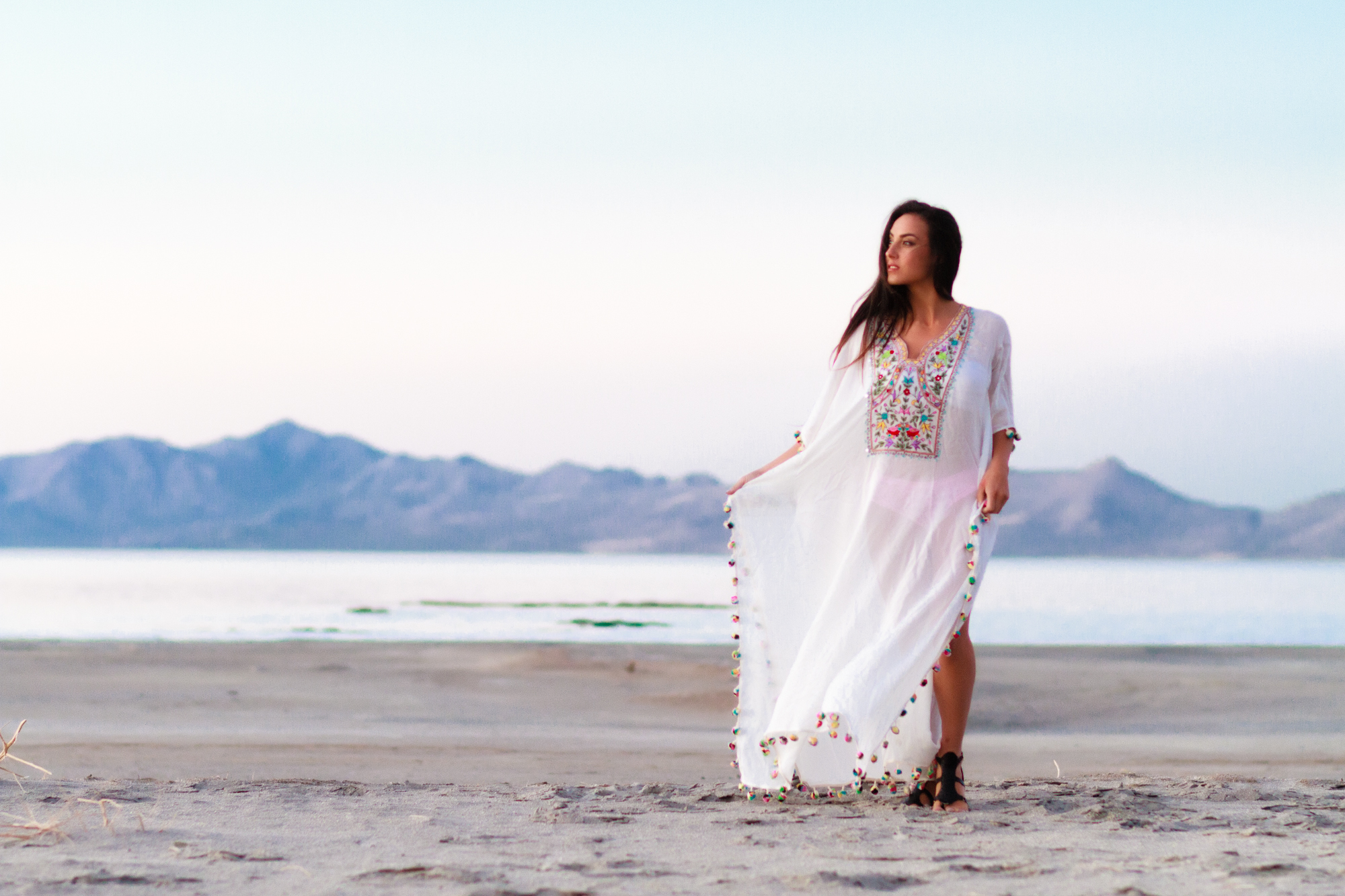 A beautiful white Boho Maxi Dress with tribal embroidery, perfect for beach weddings and casual outings, featuring a flowy design and matching inner dress.
