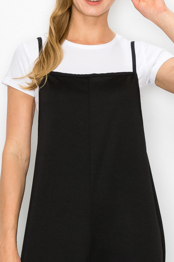 A stylish black cropped bottom wide leg oversized jumpsuit featuring spaghetti straps and a comfortable fit, perfect for casual and semi-formal occasions.