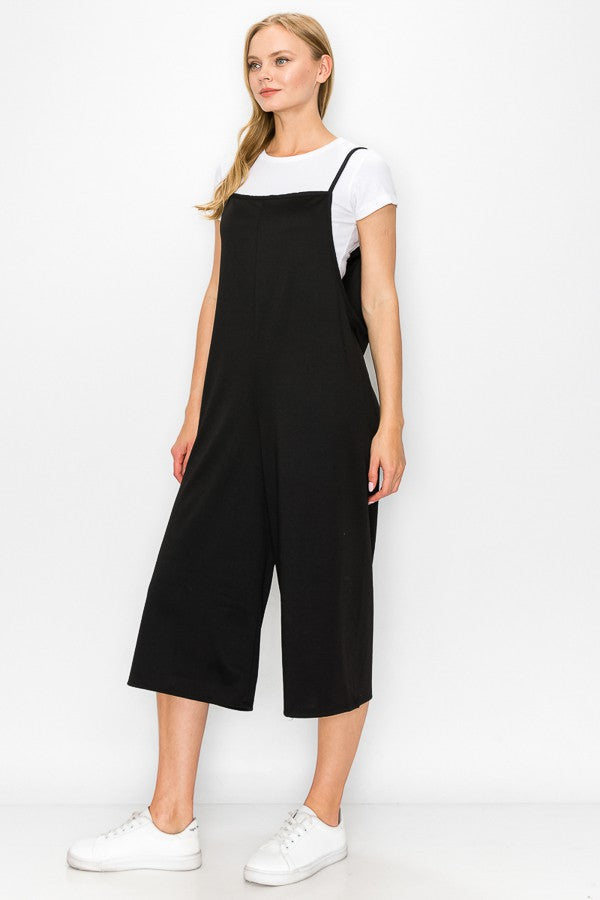 A stylish black cropped bottom wide leg oversized jumpsuit featuring spaghetti straps and a comfortable fit, perfect for casual and semi-formal occasions.