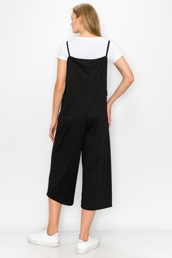 A stylish black cropped bottom wide leg oversized jumpsuit featuring spaghetti straps and a comfortable fit, perfect for casual and semi-formal occasions.
