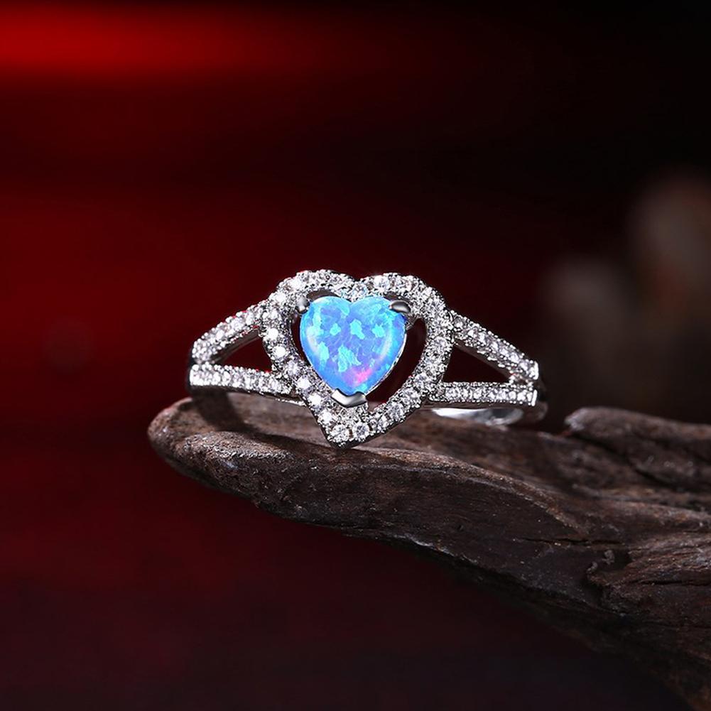 Elegant heart-shaped cut opal ring set in 18K white gold, showcasing vibrant colors and a delicate design.
