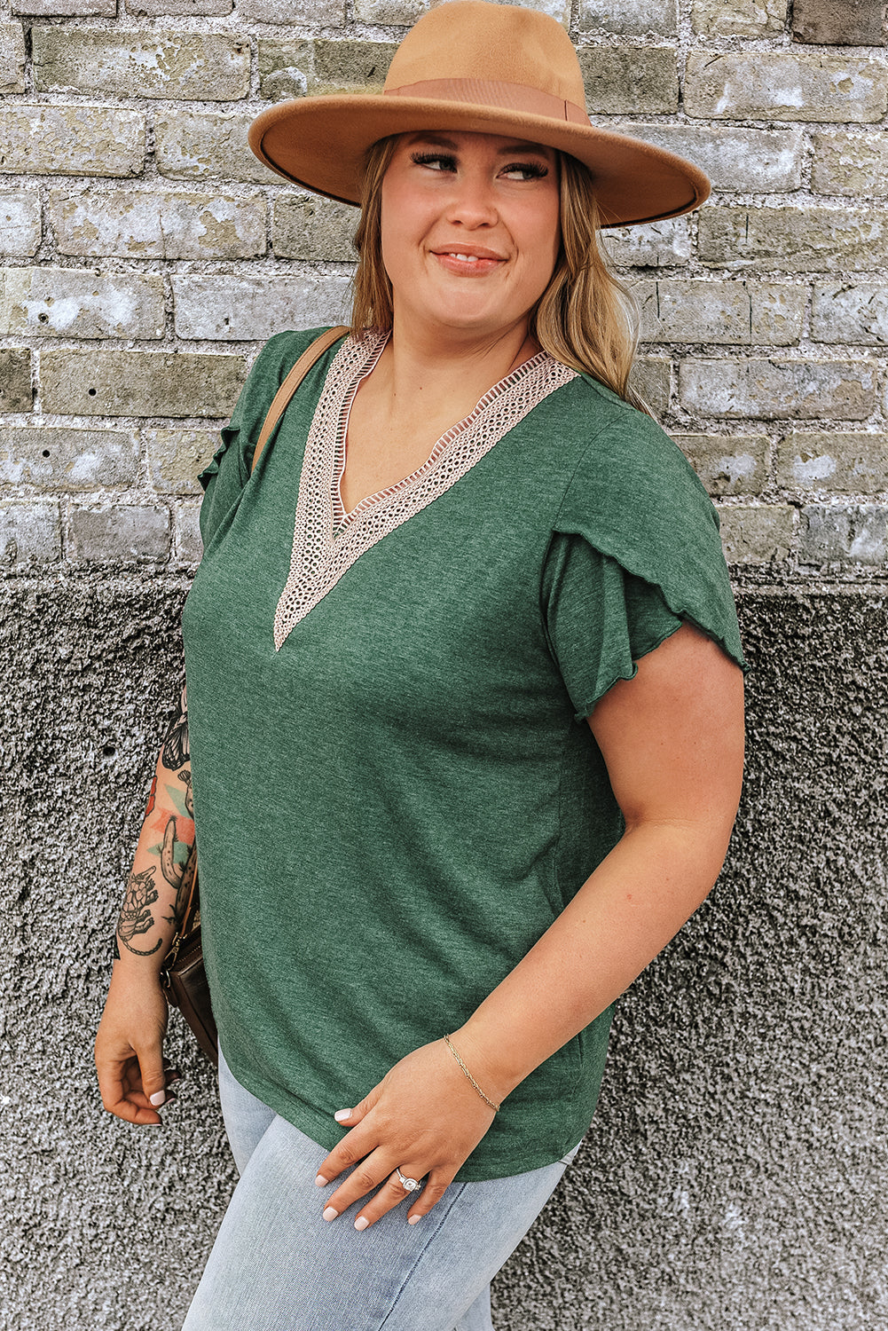 A stylish plus size blouse featuring intricate embroidery and a flattering V-neckline, designed for comfort and elegance.