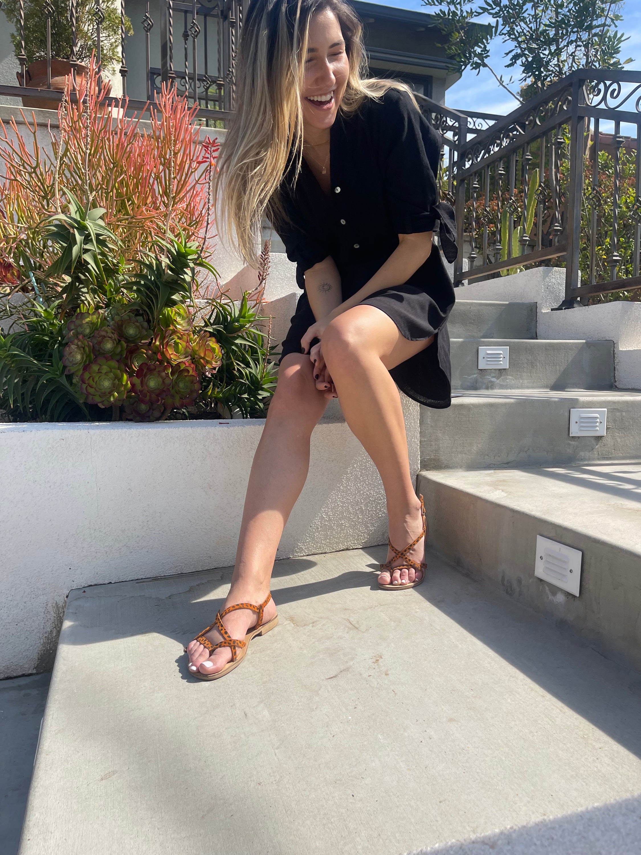 The SHERV Mini Dress in Black, featuring adjustable tie sleeves and a loose fit, made from lightweight 100% cotton, perfect for summer wear.