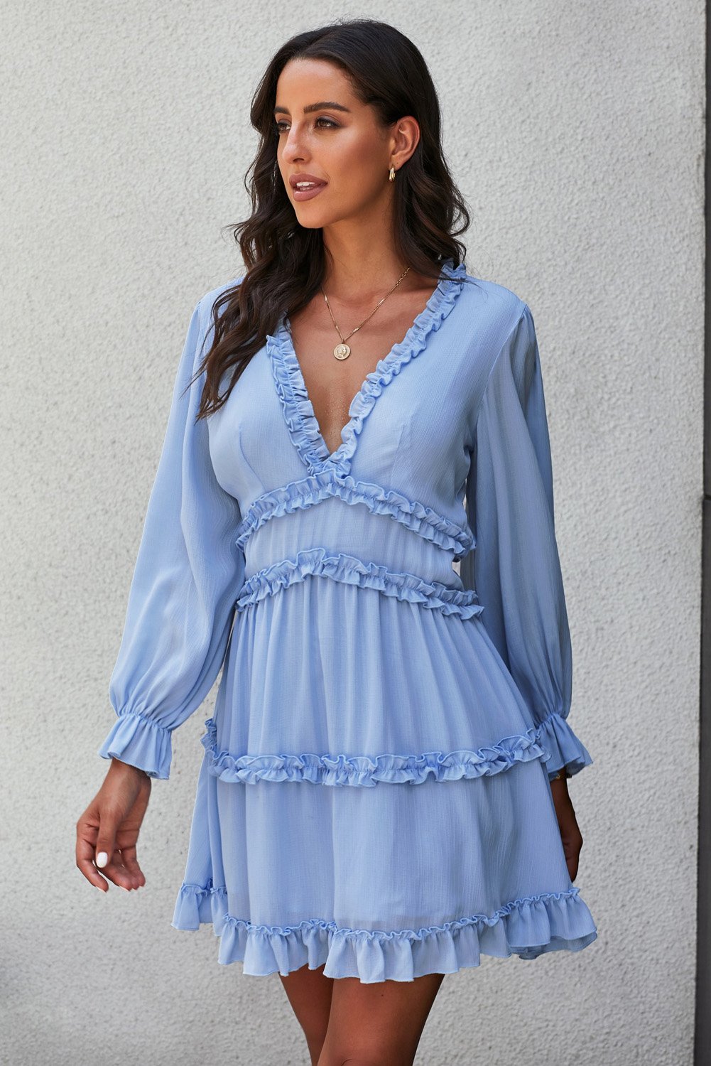 Sky blue long sleeve dress featuring v-neckline, ruffle detailing, and open back design, perfect for casual occasions.