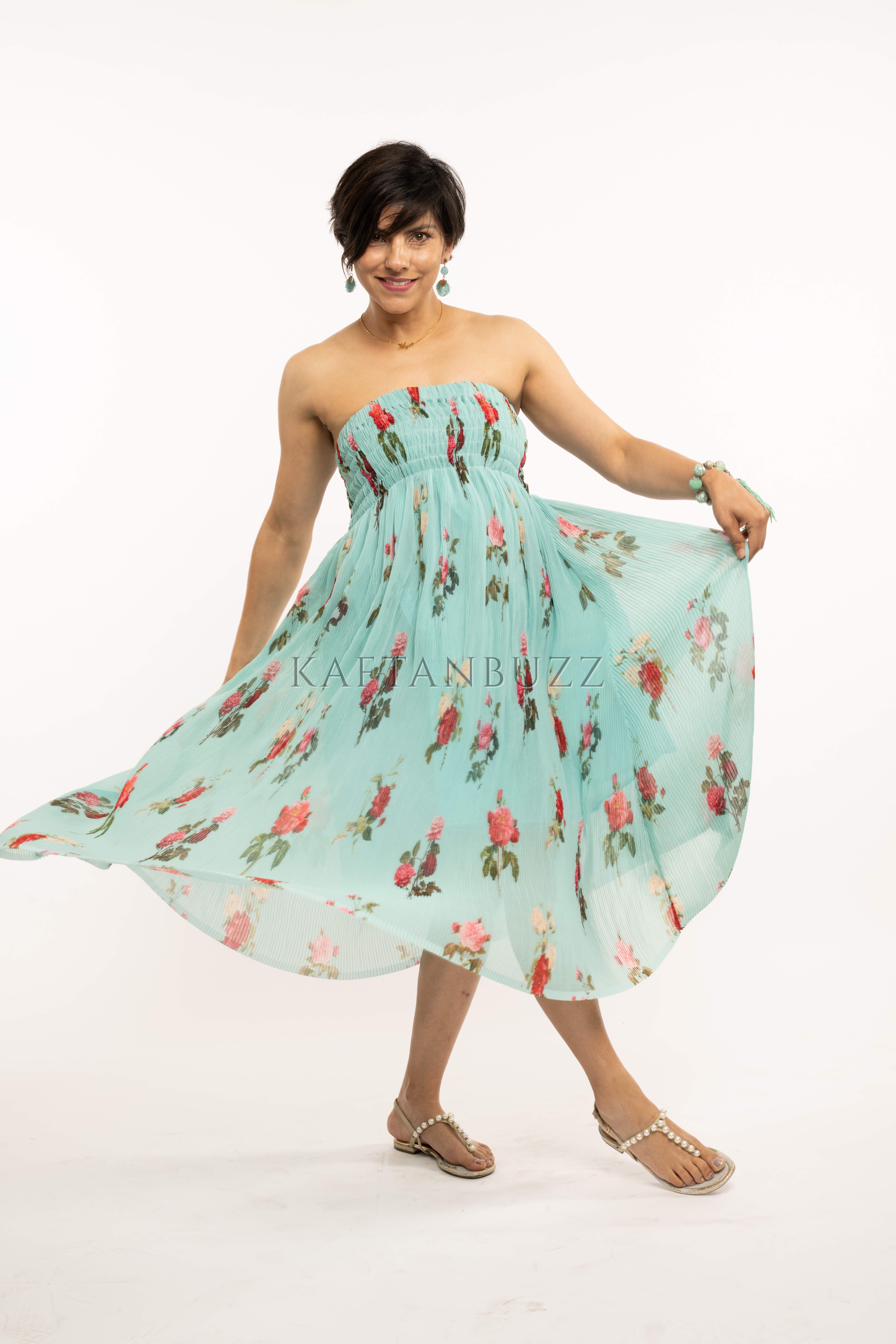 A stylish off-the-shoulder floral midi dress in blue tropical print, made from lightweight crushed georgette fabric, perfect for spring and summer occasions.