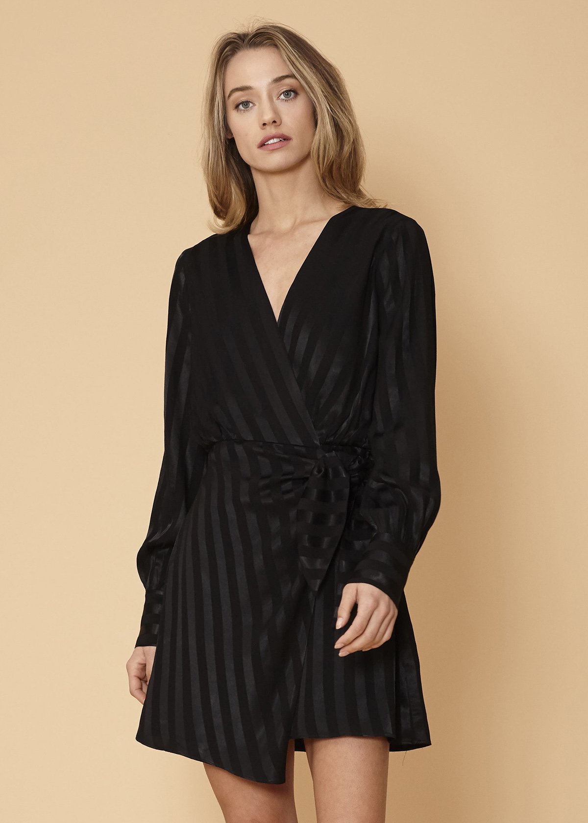 Nurode Stripe Satin Long Sleeve Mini Dress in Black showcasing elegant design with long sleeves and side tie-up detail.