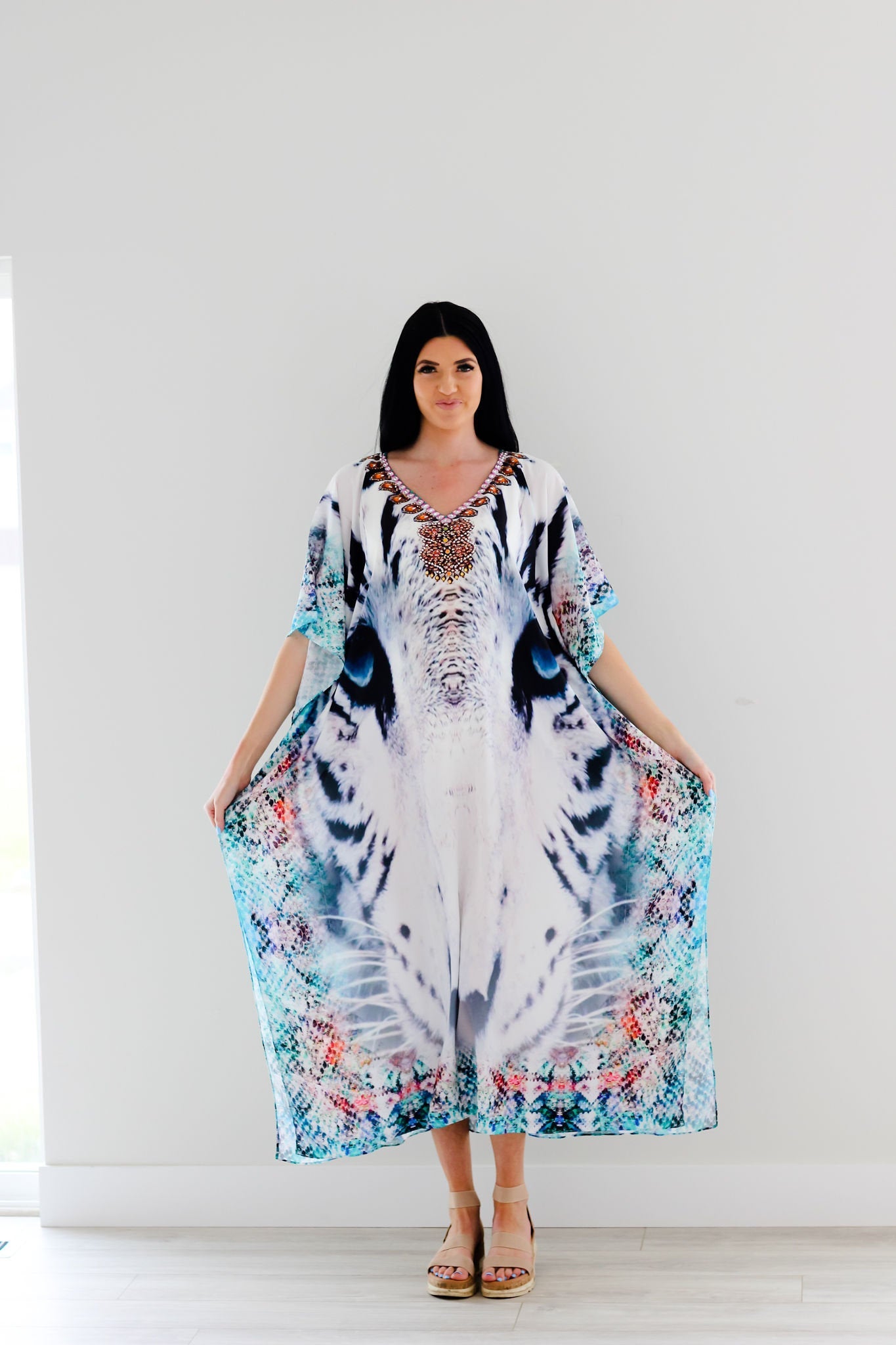 A vibrant Tribal Kaftan Dress featuring multicolored patterns and embellishments, perfect for beach outings and casual wear.