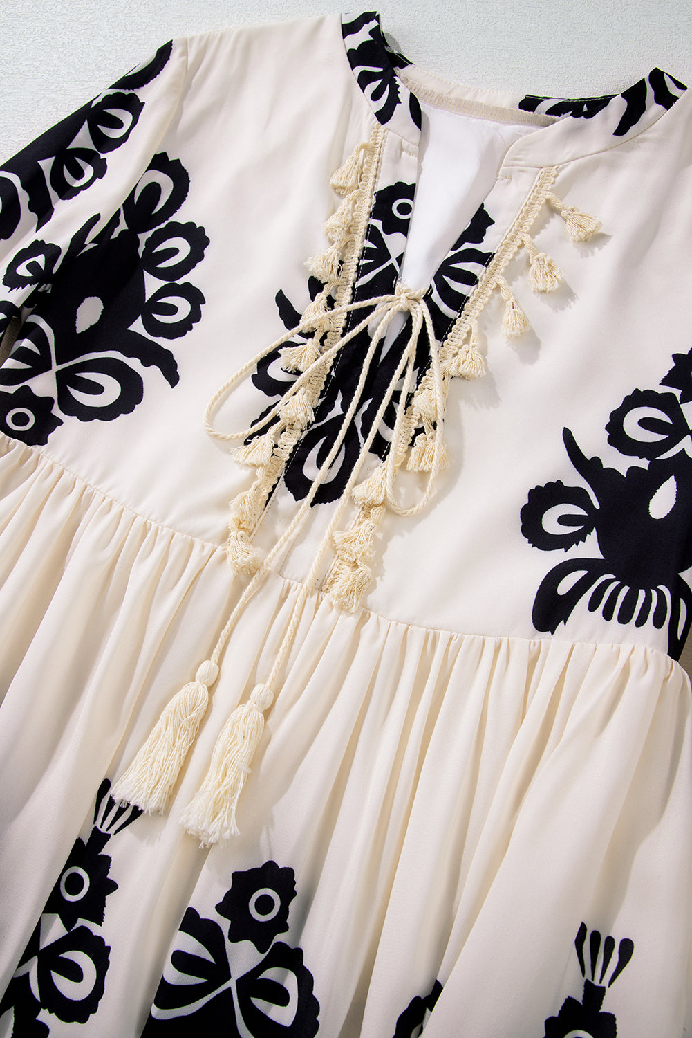 A vibrant Western Pattern Tasseled Notch Mini Dress featuring chic tassels and dynamic geometric patterns, perfect for stylish occasions.