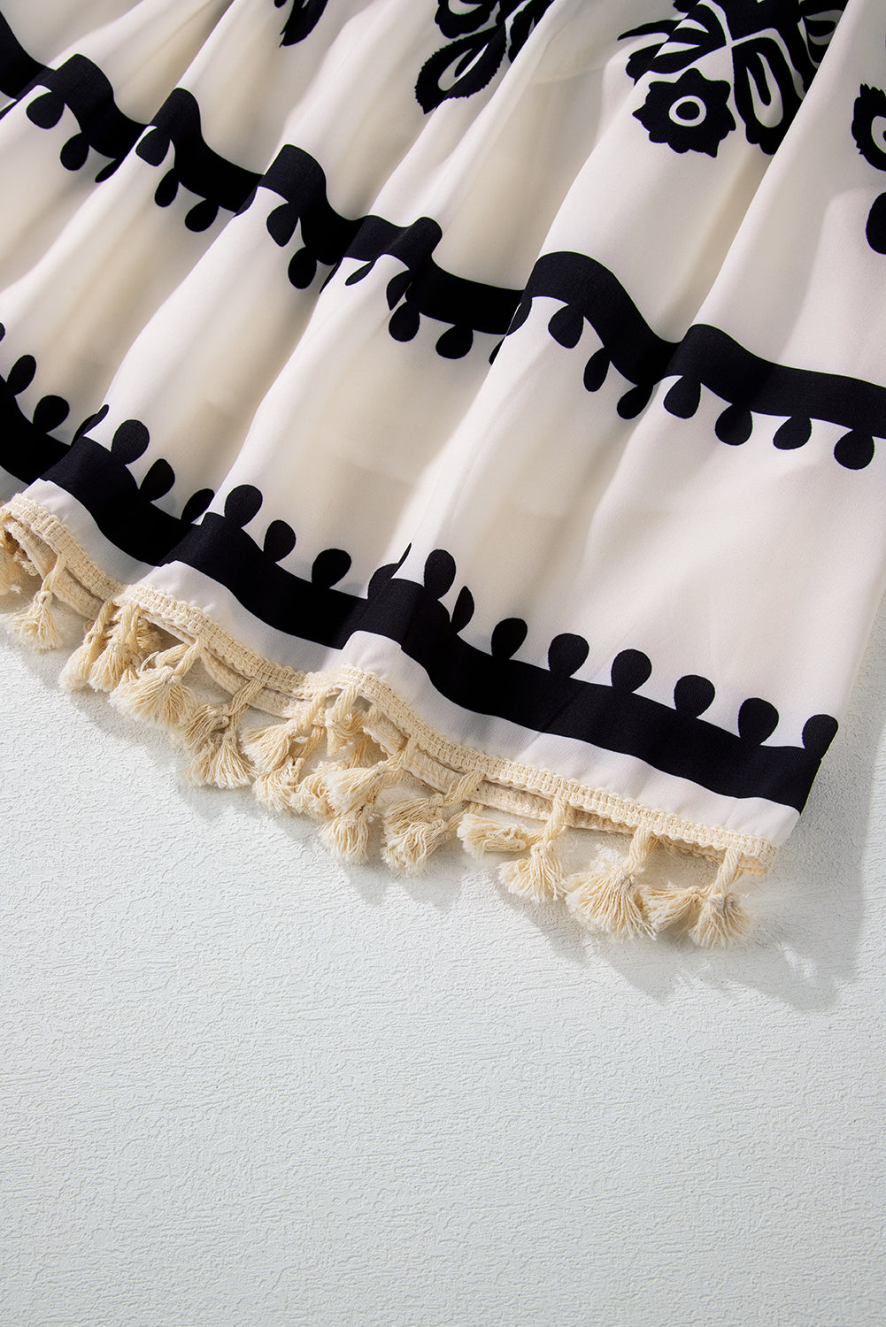 A vibrant Western Pattern Tasseled Notch Mini Dress featuring chic tassels and dynamic geometric patterns, perfect for stylish occasions.