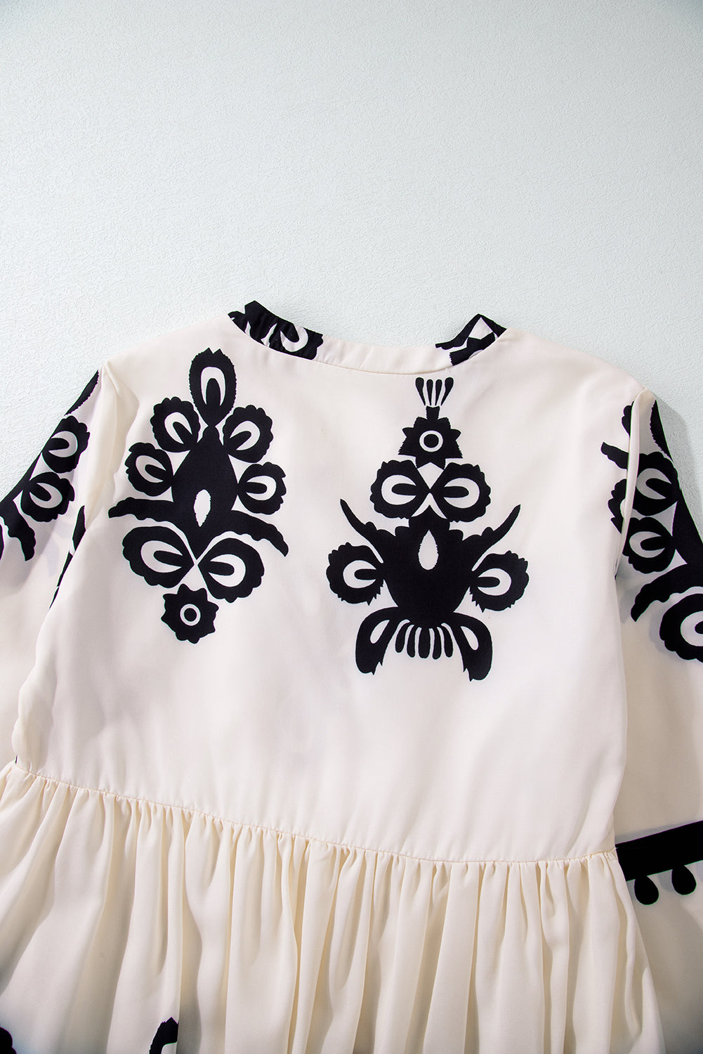 A vibrant Western Pattern Tasseled Notch Mini Dress featuring chic tassels and dynamic geometric patterns, perfect for stylish occasions.