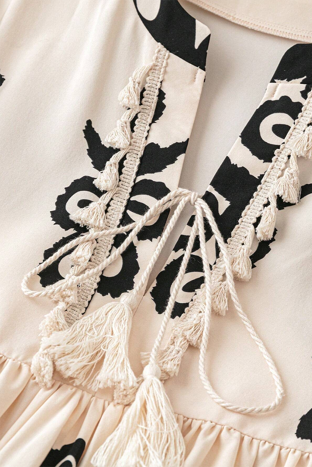 A vibrant Western Pattern Tasseled Notch Mini Dress featuring chic tassels and dynamic geometric patterns, perfect for stylish occasions.