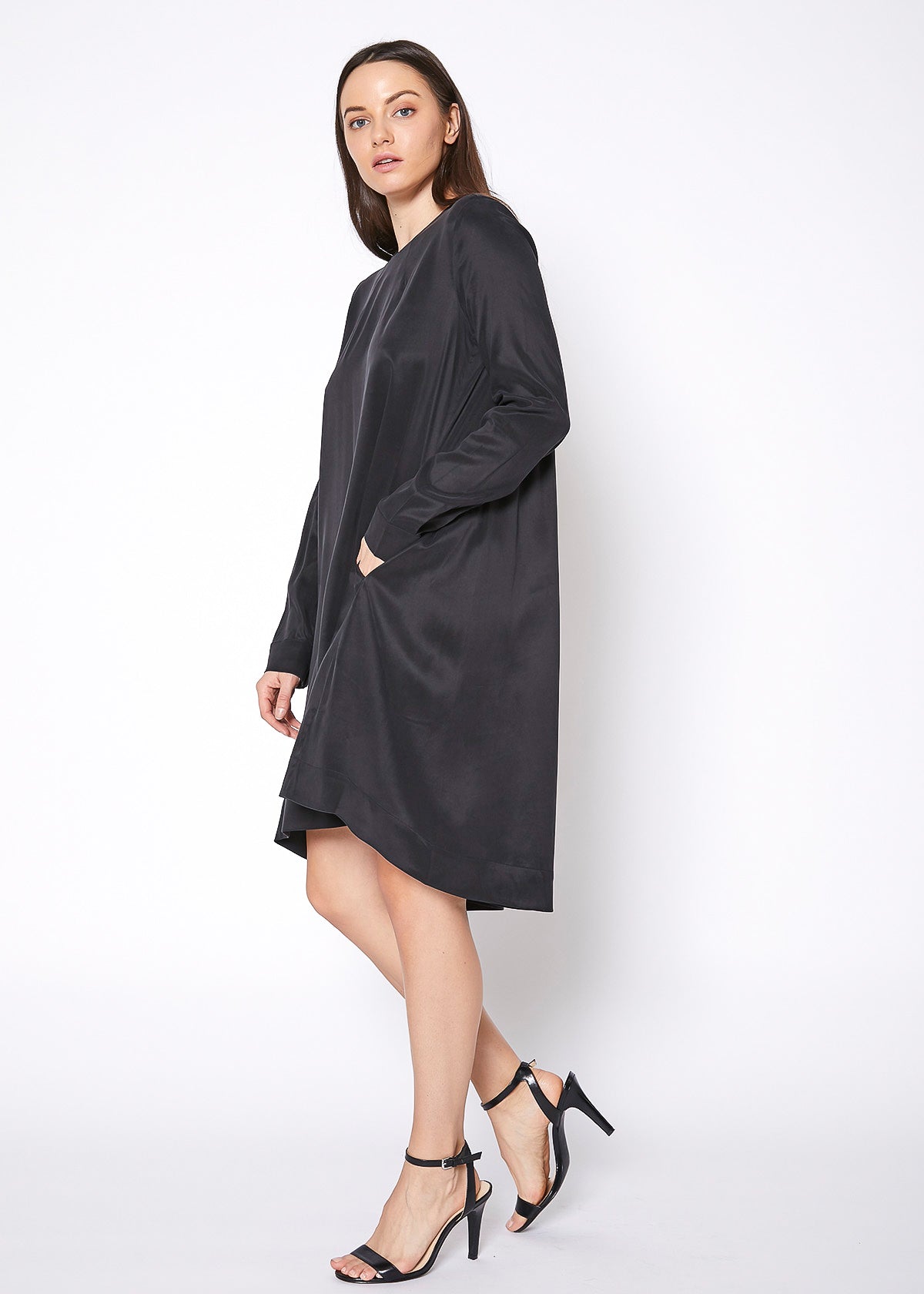 A stylish Women's Basic Long Sleeve Crew Neck Dress displayed on a mannequin, showcasing its elegant drape and comfortable fit.